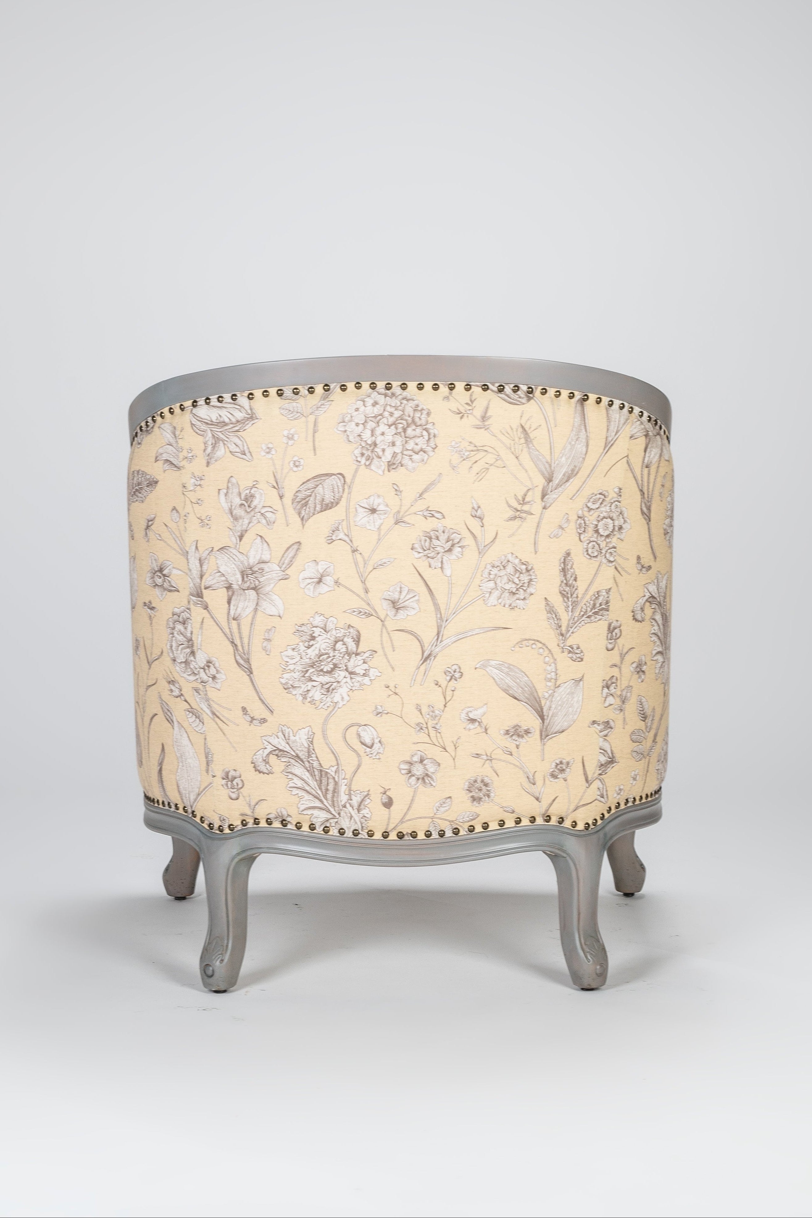 Decorative stool with floral patterned top and gray base on a white background