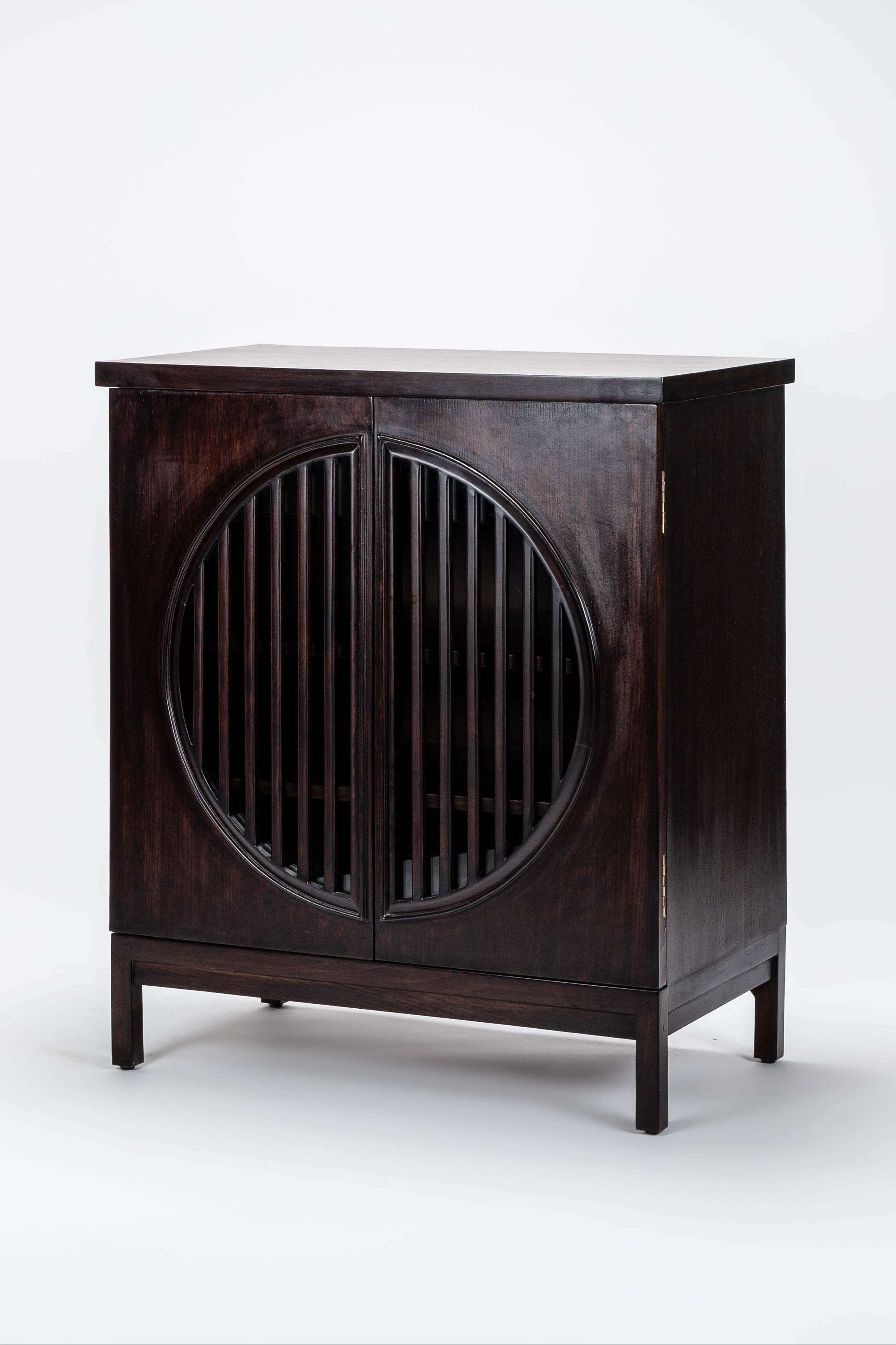 Dark wooden cabinet with circular design on a white background