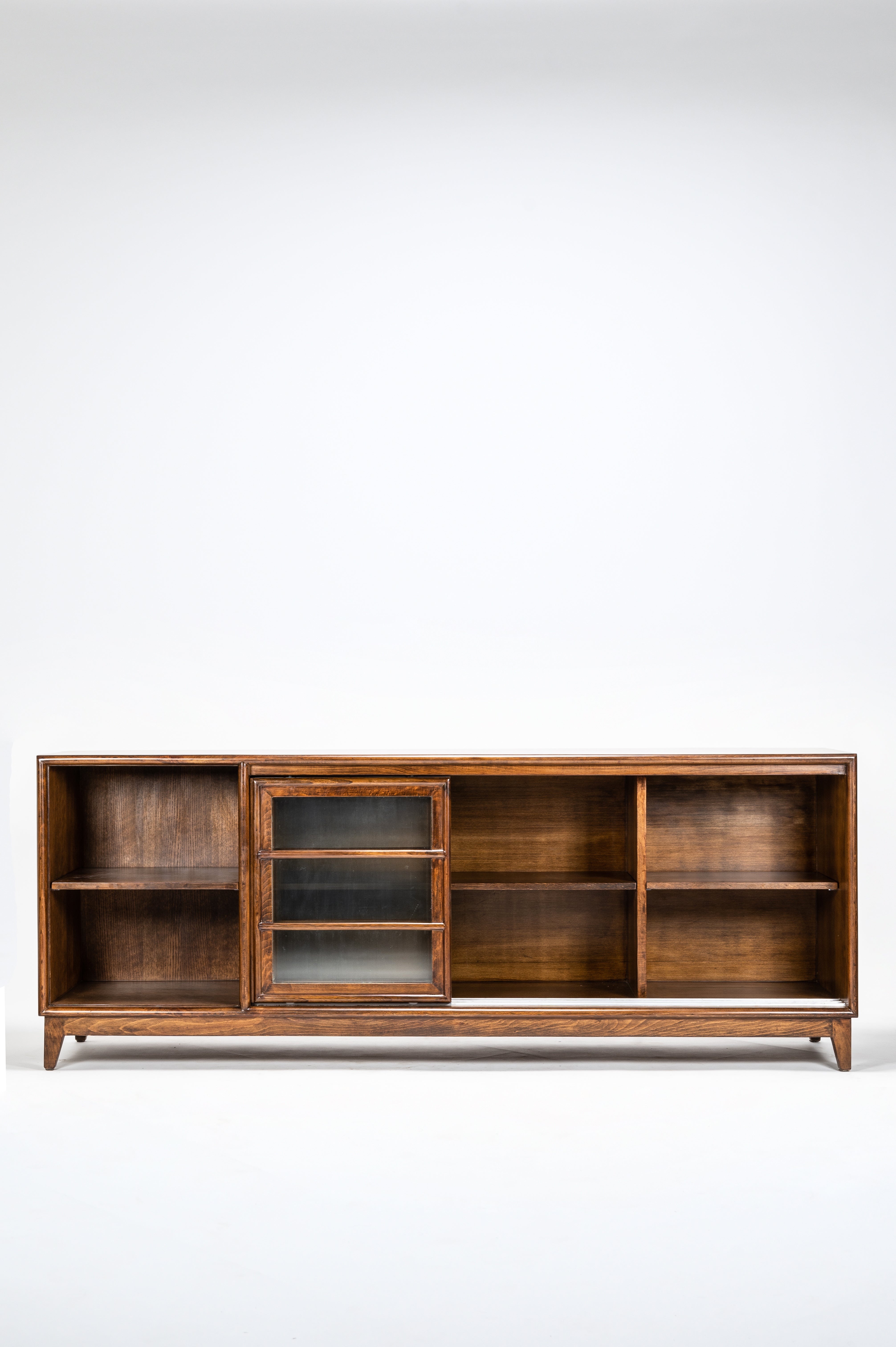 Wooden bookshelf with glass doors on a white background