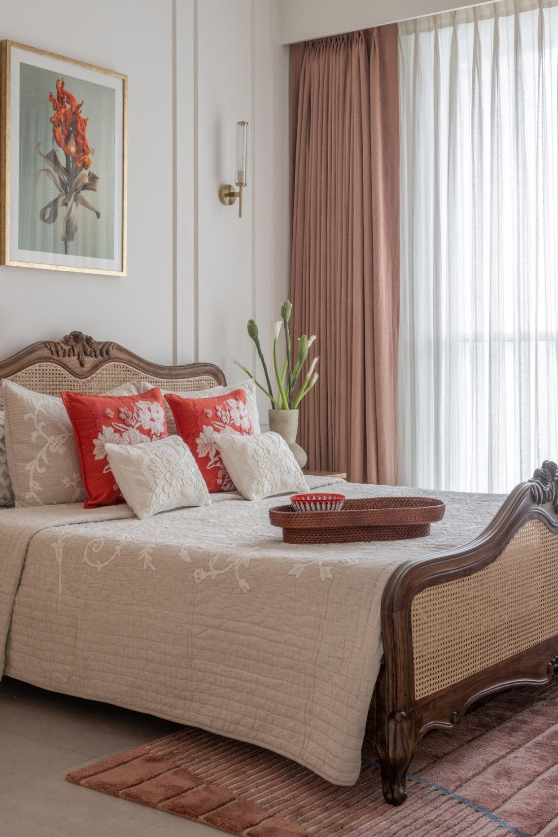 Decorative bedroom with a bed, pillows, and a painting on the wall.