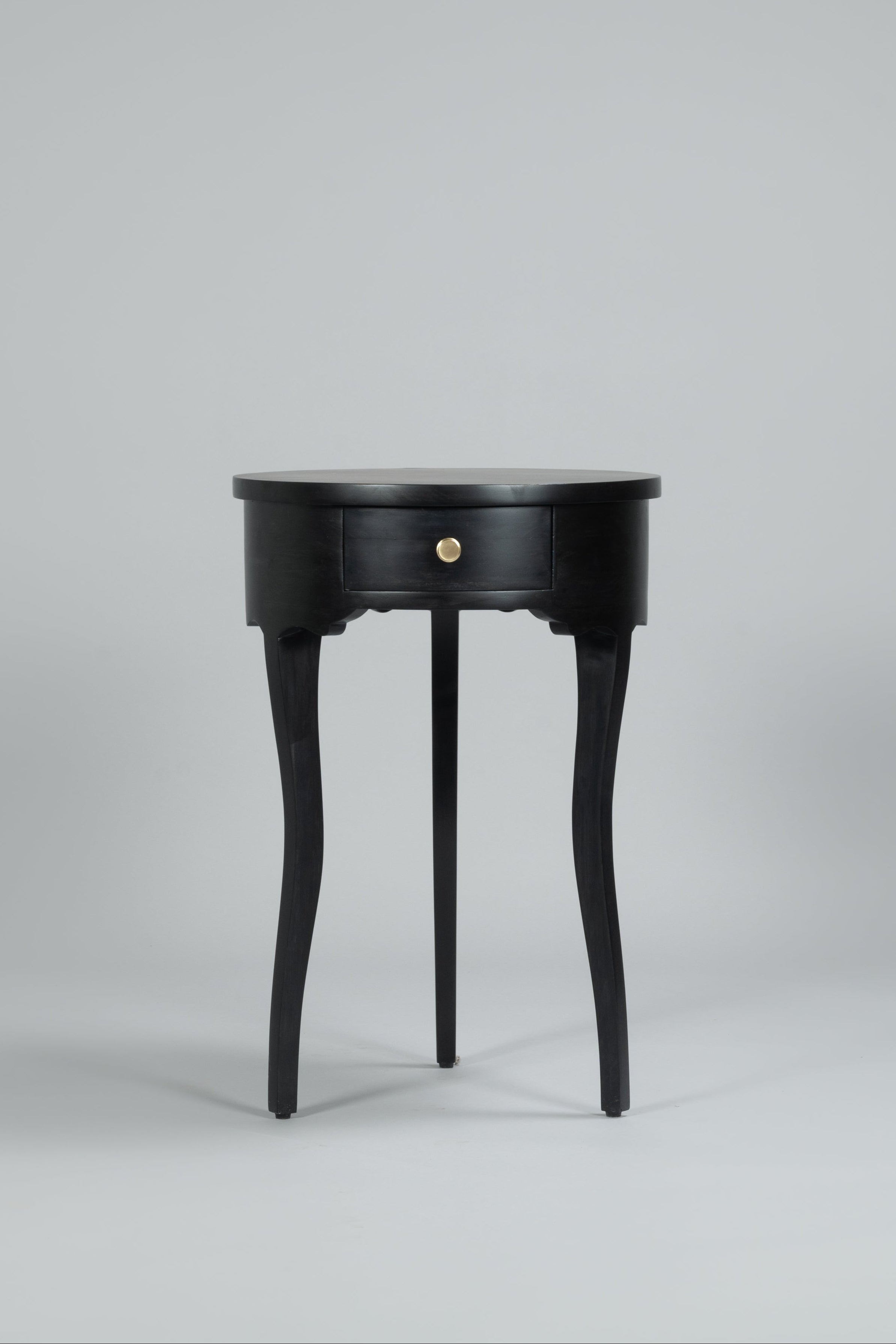 Black side table with a round top and legs on a gray background
