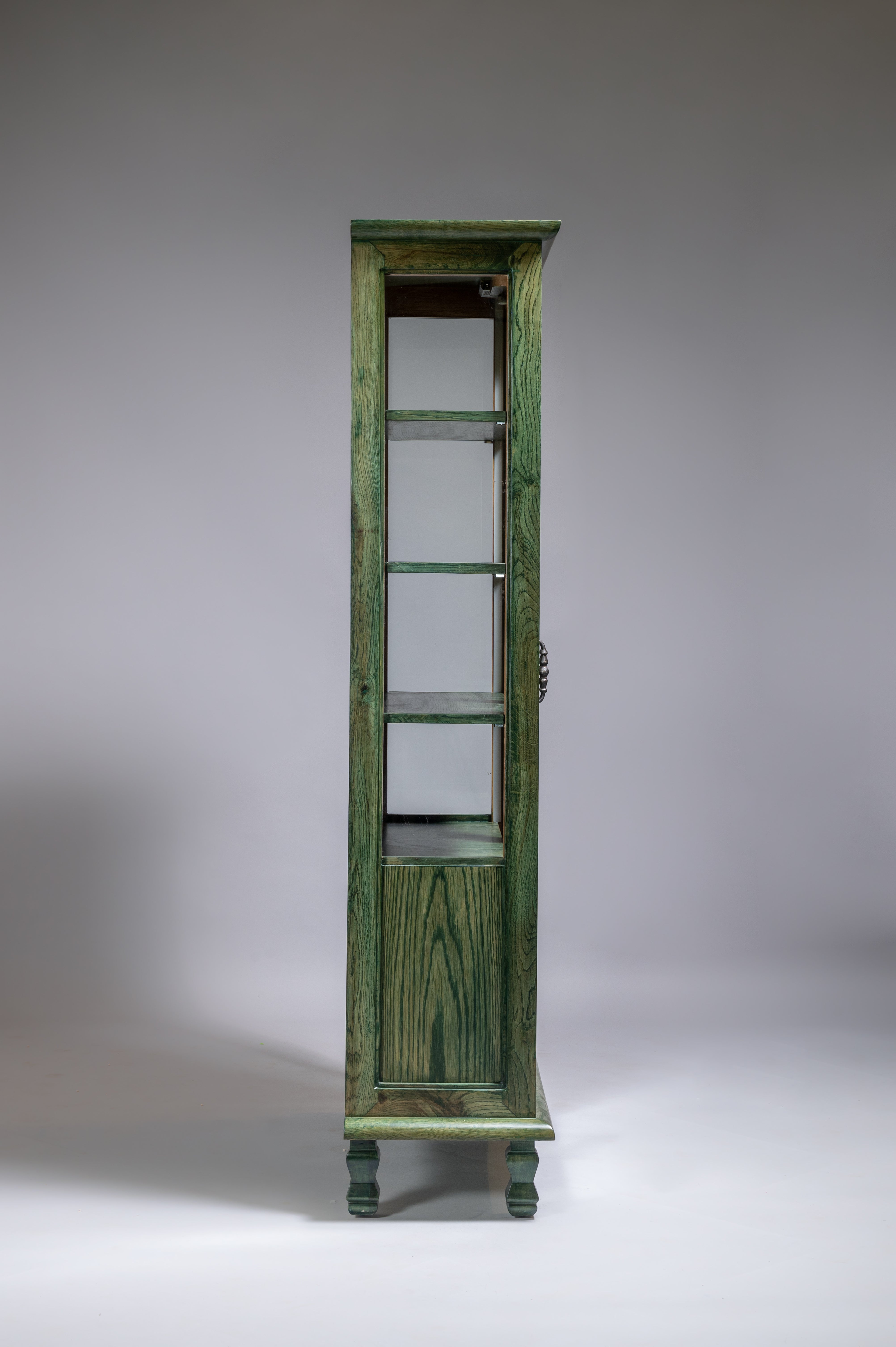 Green wooden display cabinet on a gray background