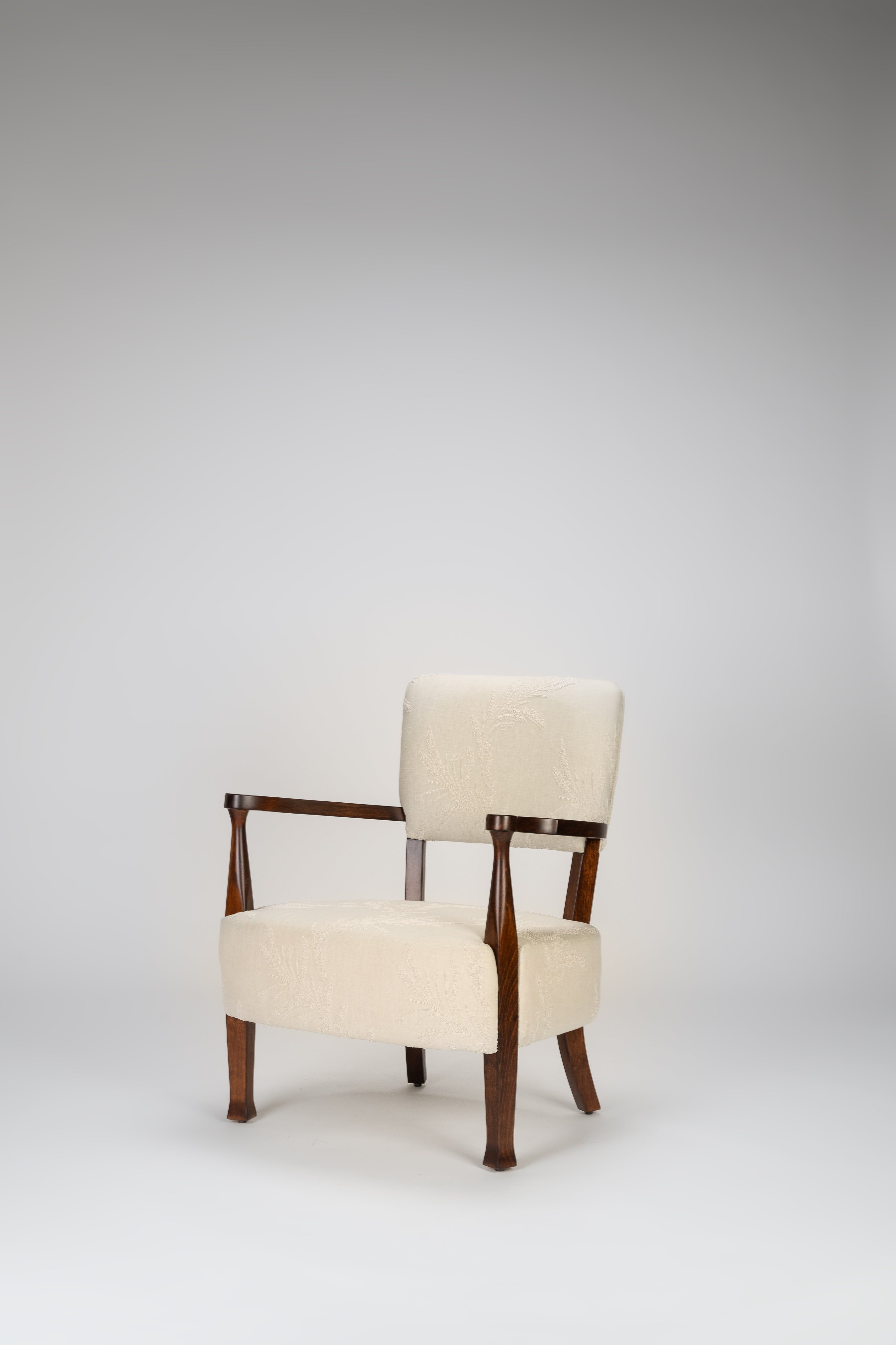 Chair with wooden frame and white cushion on a gray background
