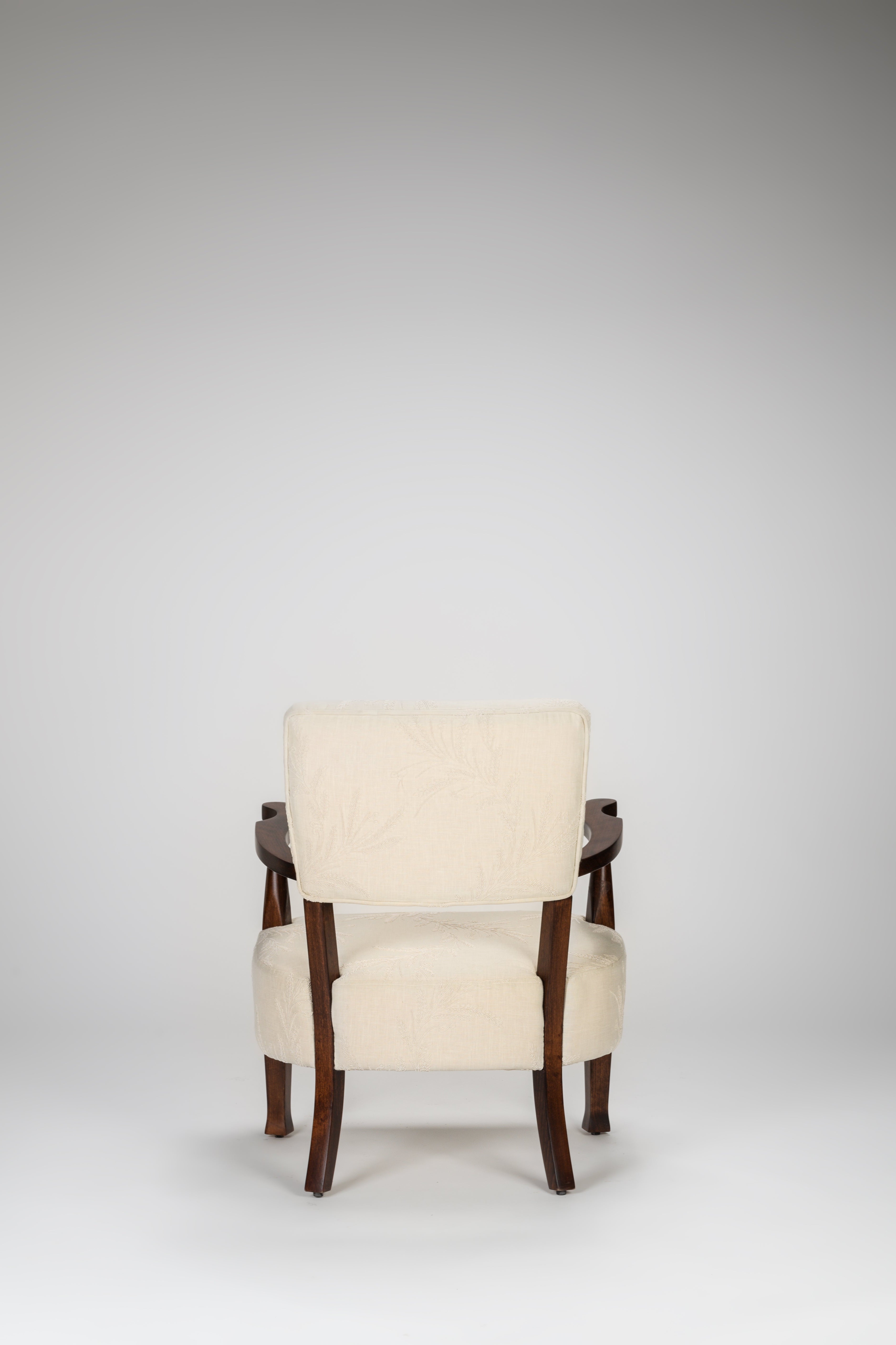 Beige armchair with wooden arms on a white background