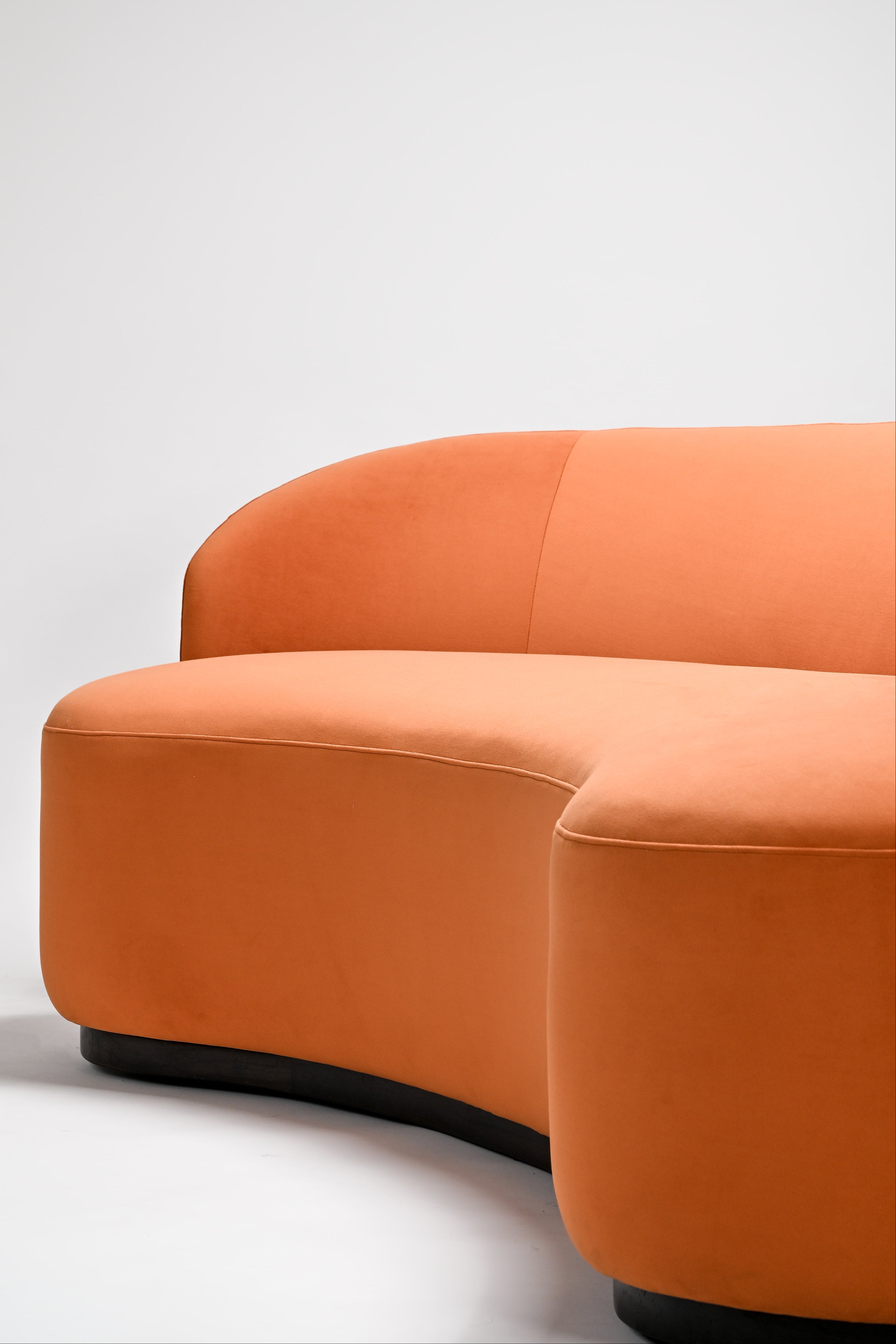 Orange curved sofa on a white background