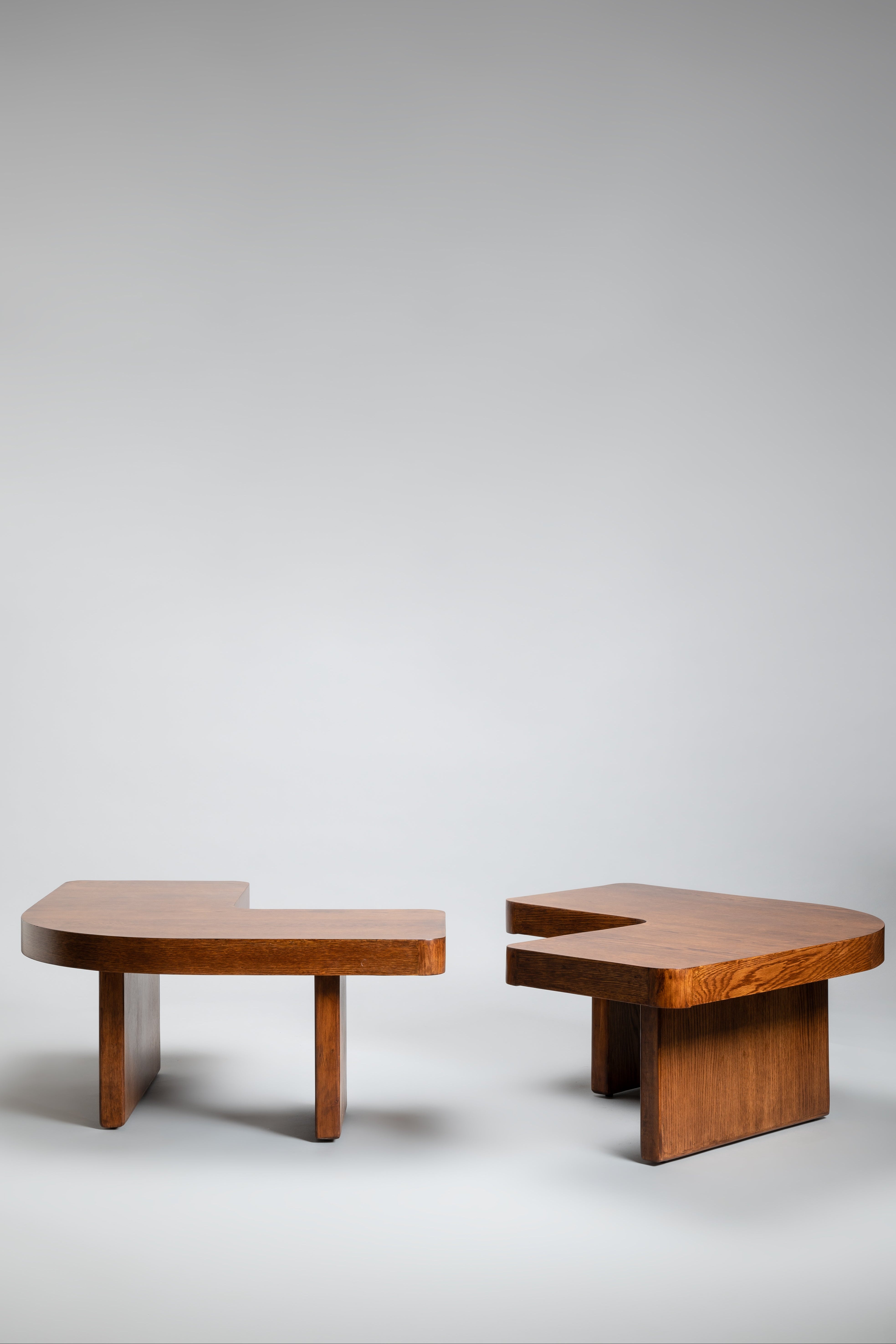 Two wooden coffee tables with a unique design on a plain background
