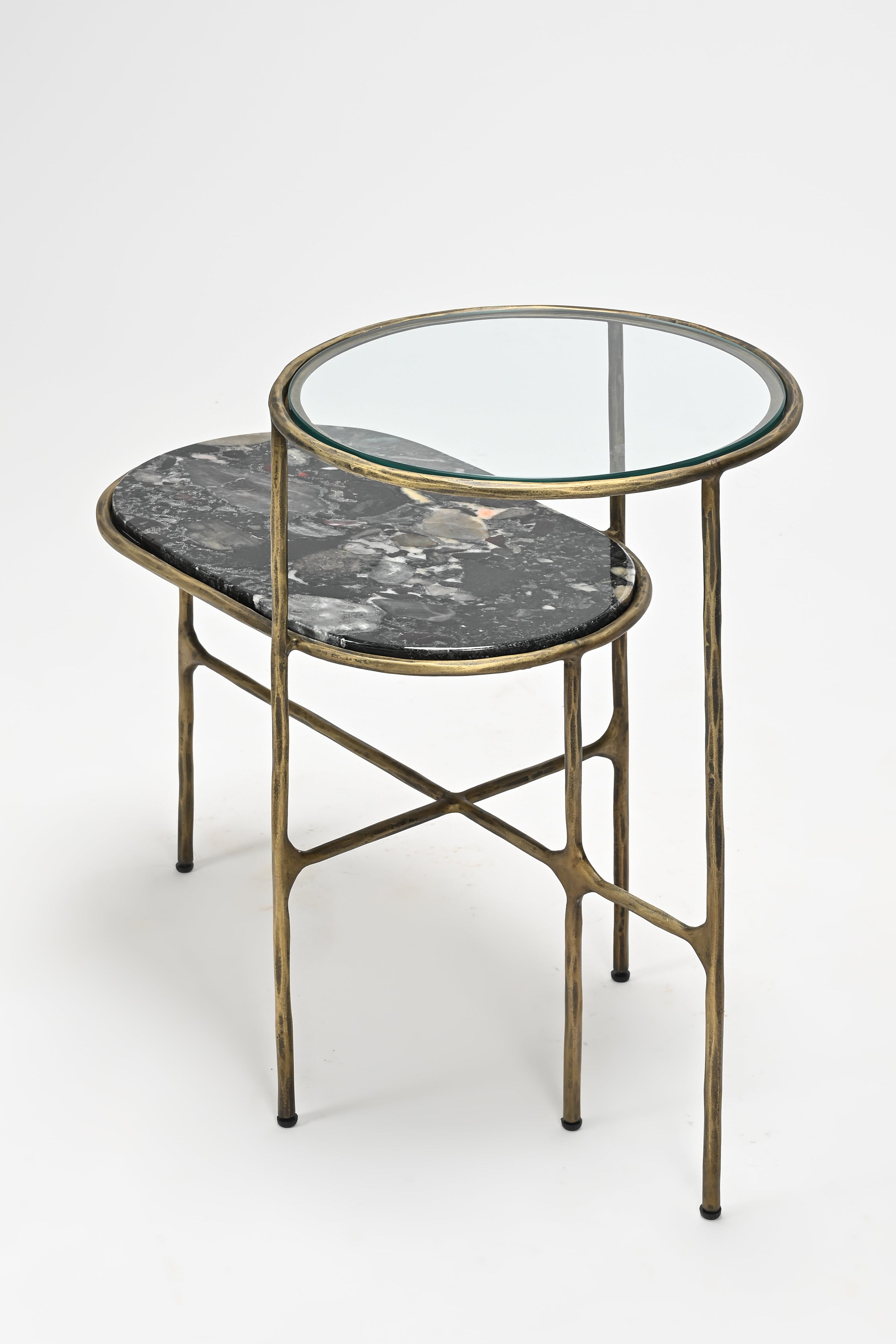 Side table with marble top and glass shelf on a white background