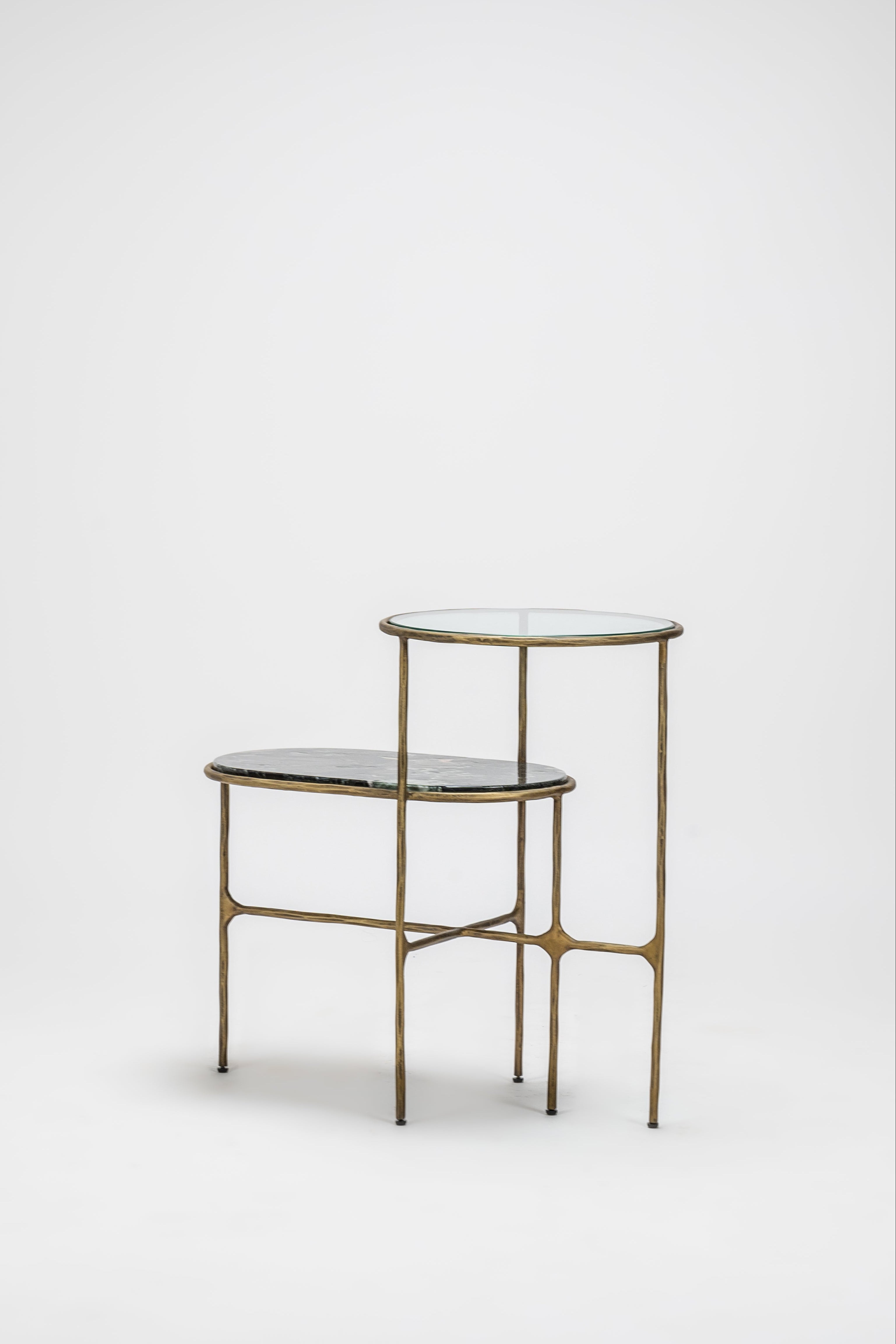 Small brass side table with two shelves on a white background