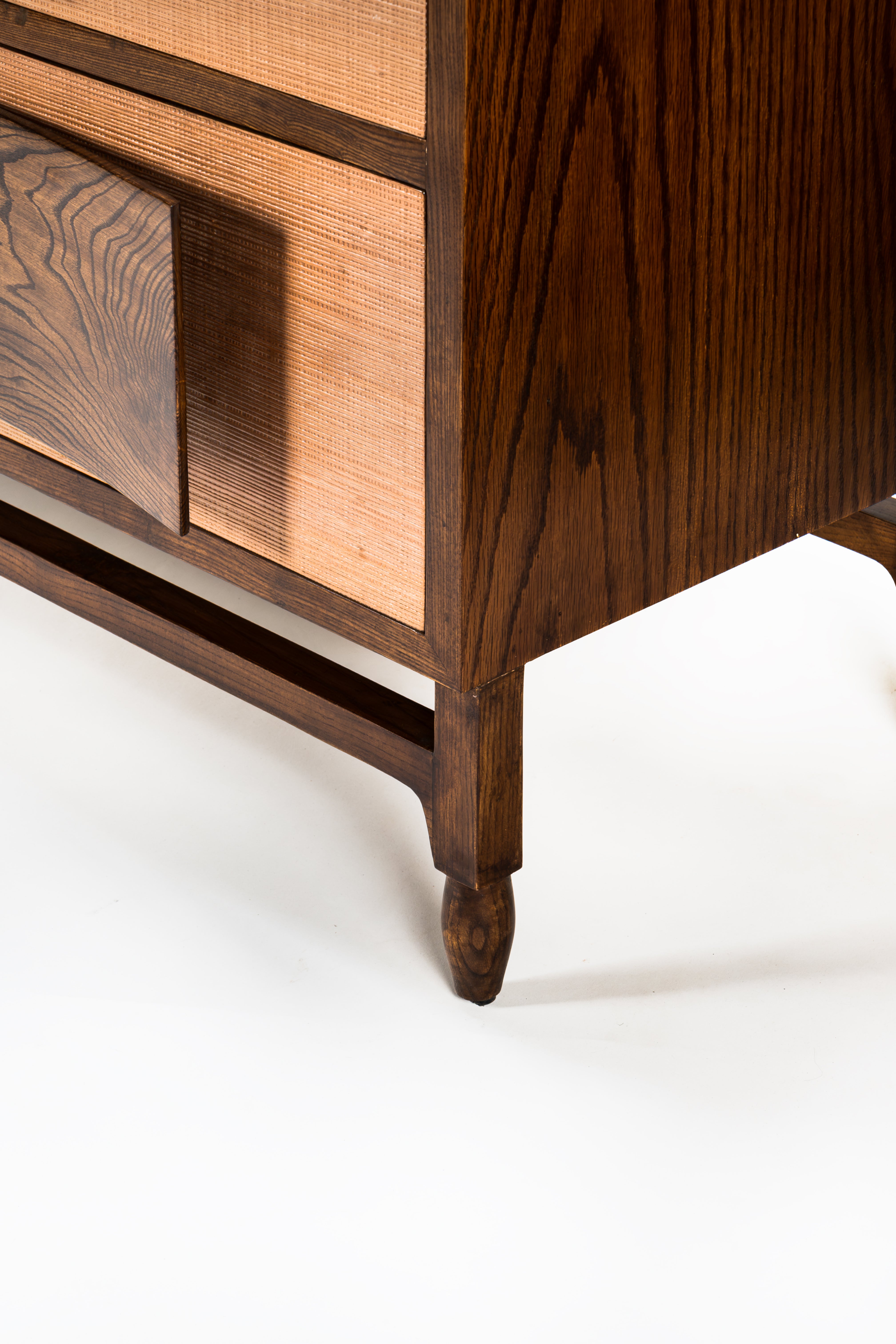 Wooden cabinet with a focus on the corner and leg on a white background