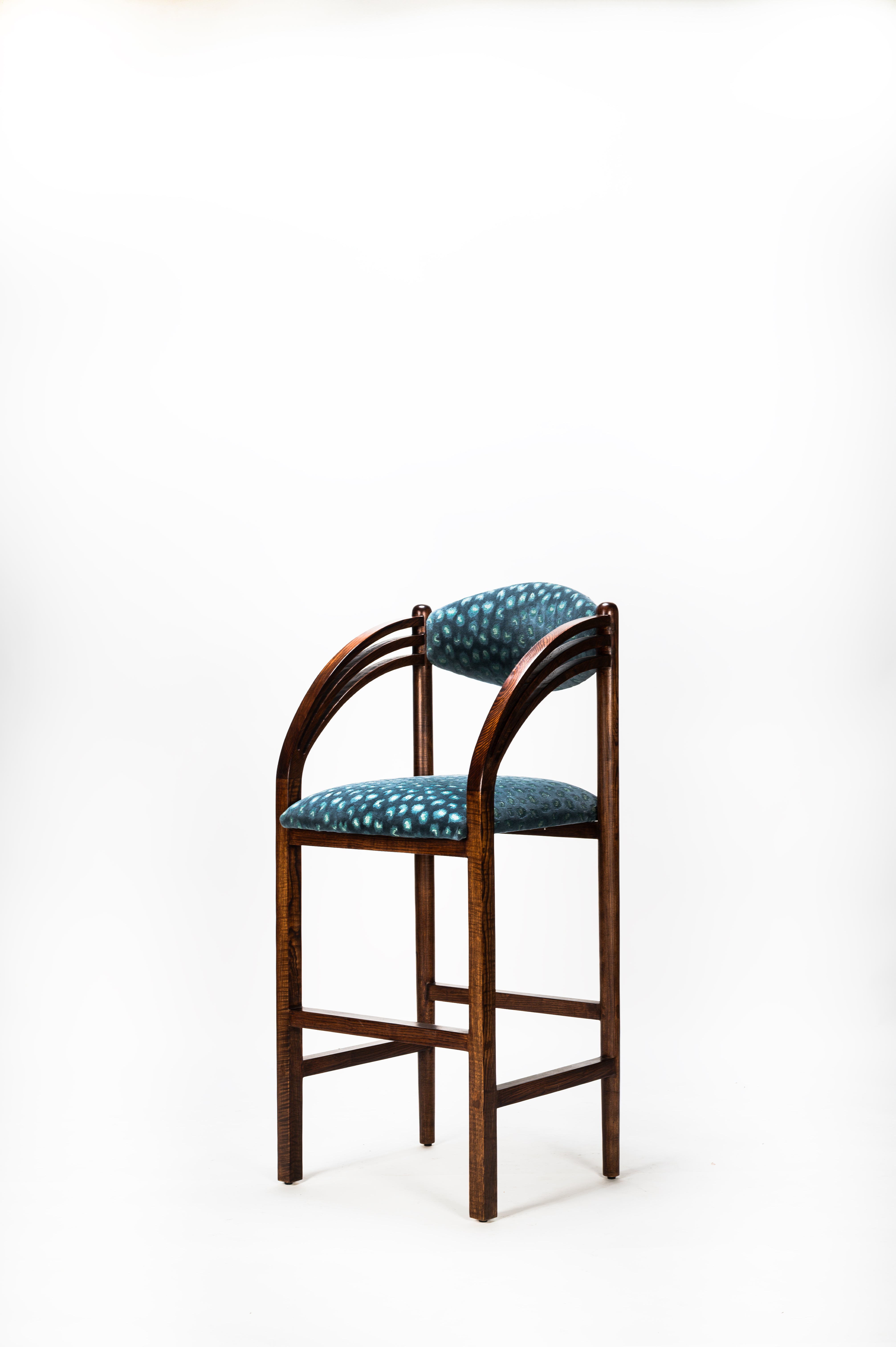 Wooden chair with blue cushioned seat and backrest on a white background