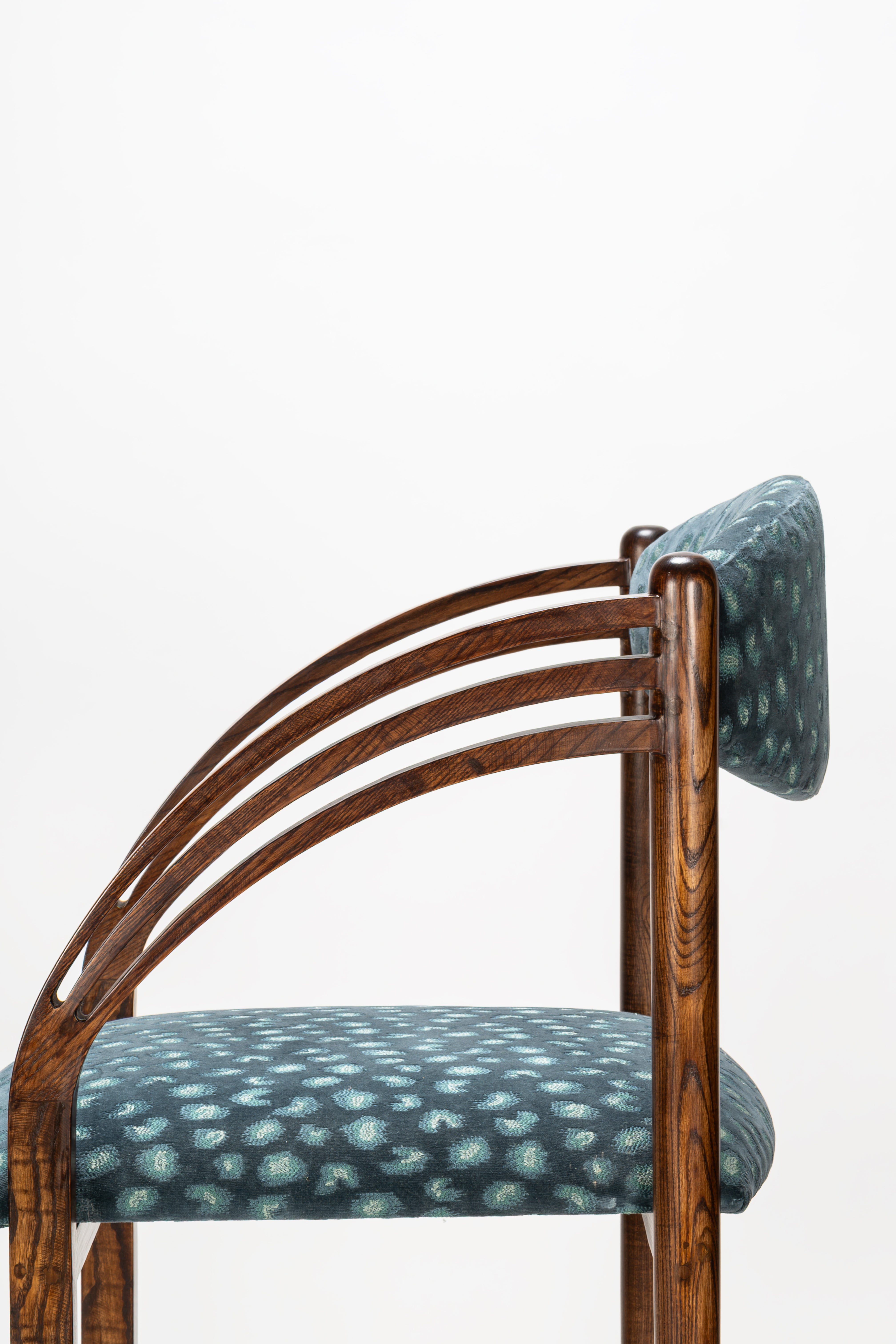 Chair with wooden frame and patterned fabric seat and backrest on a white background