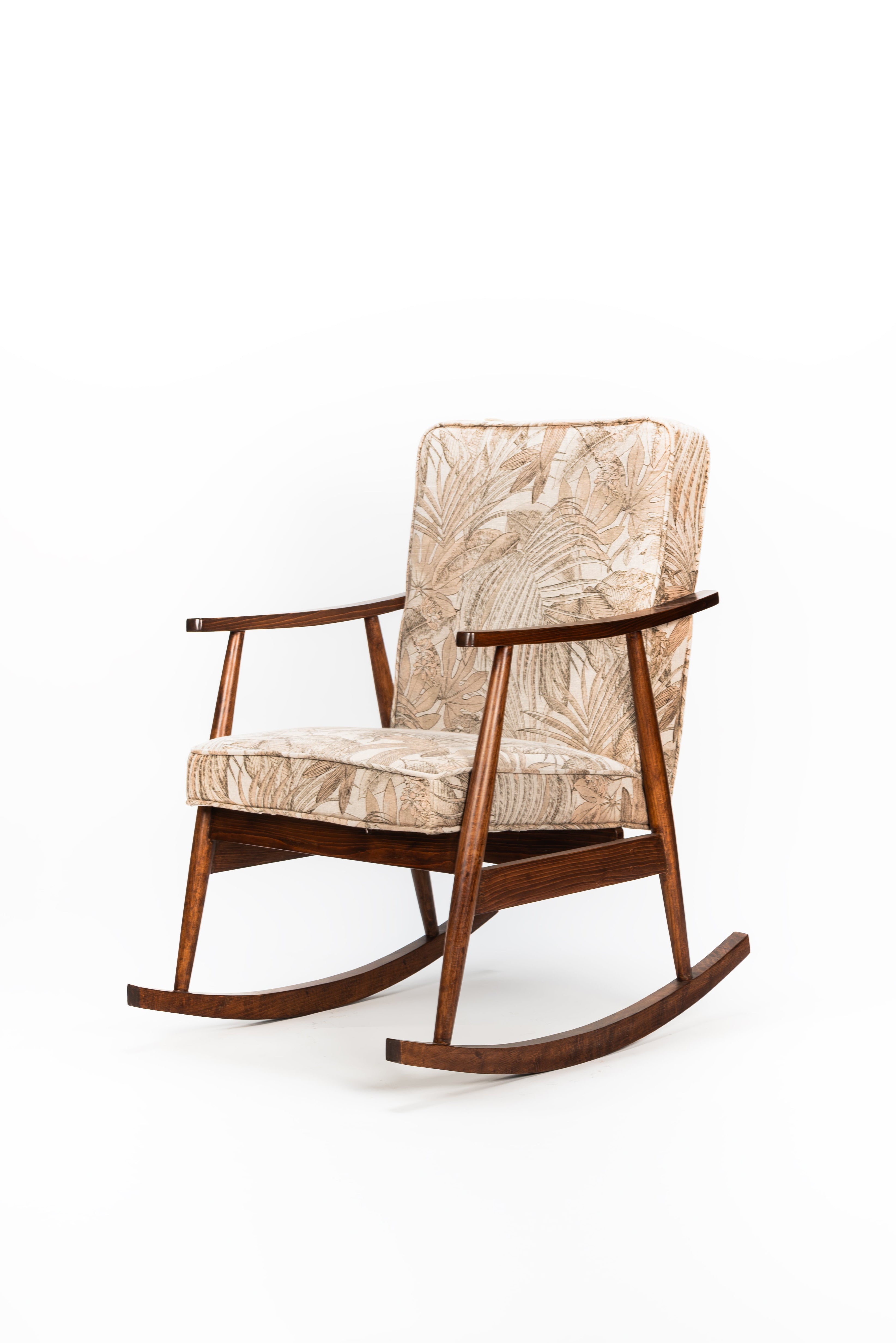 Rustic rocking chair with patterned cushion on a white background