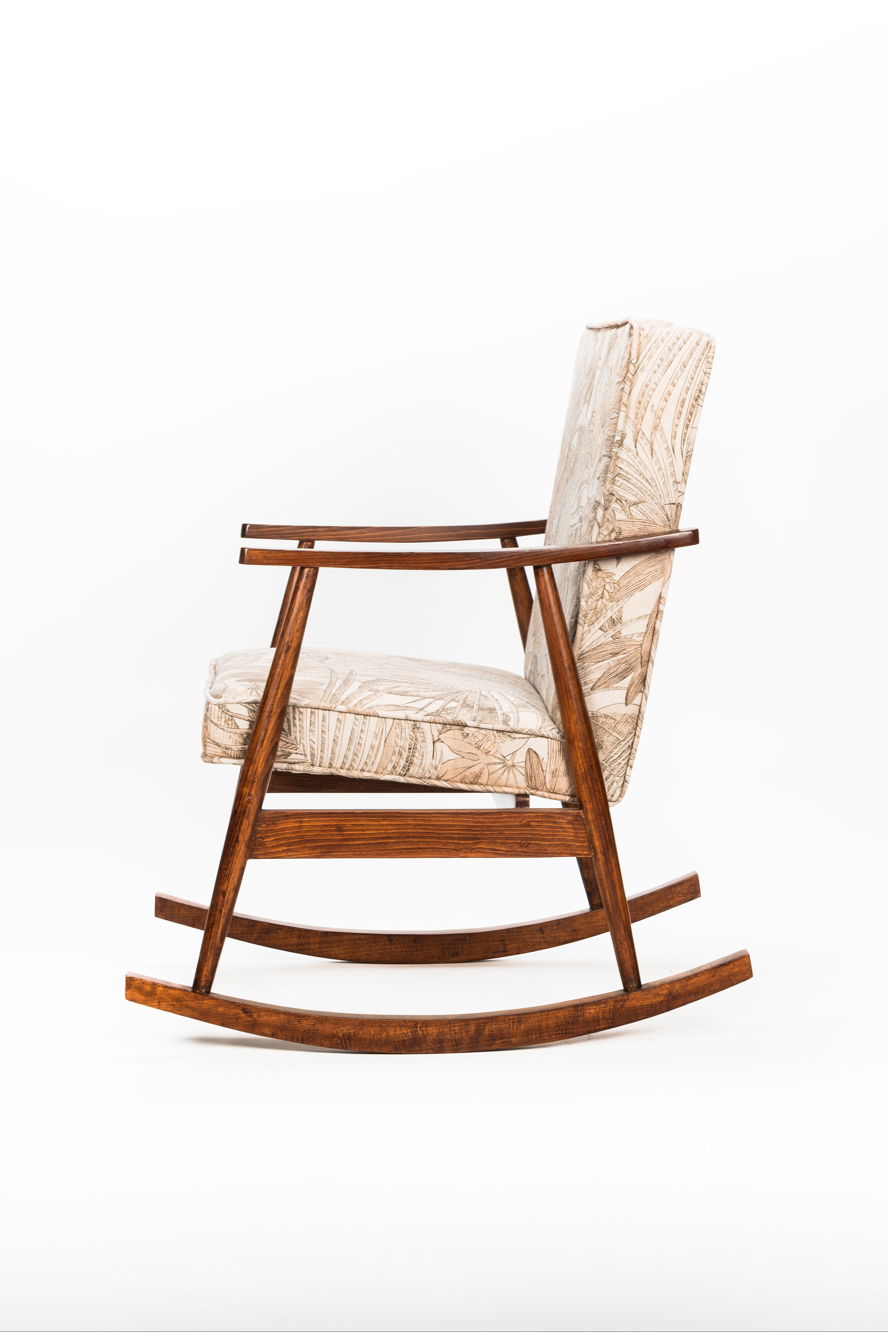 Wooden rocking chair with woven seat on a white background
