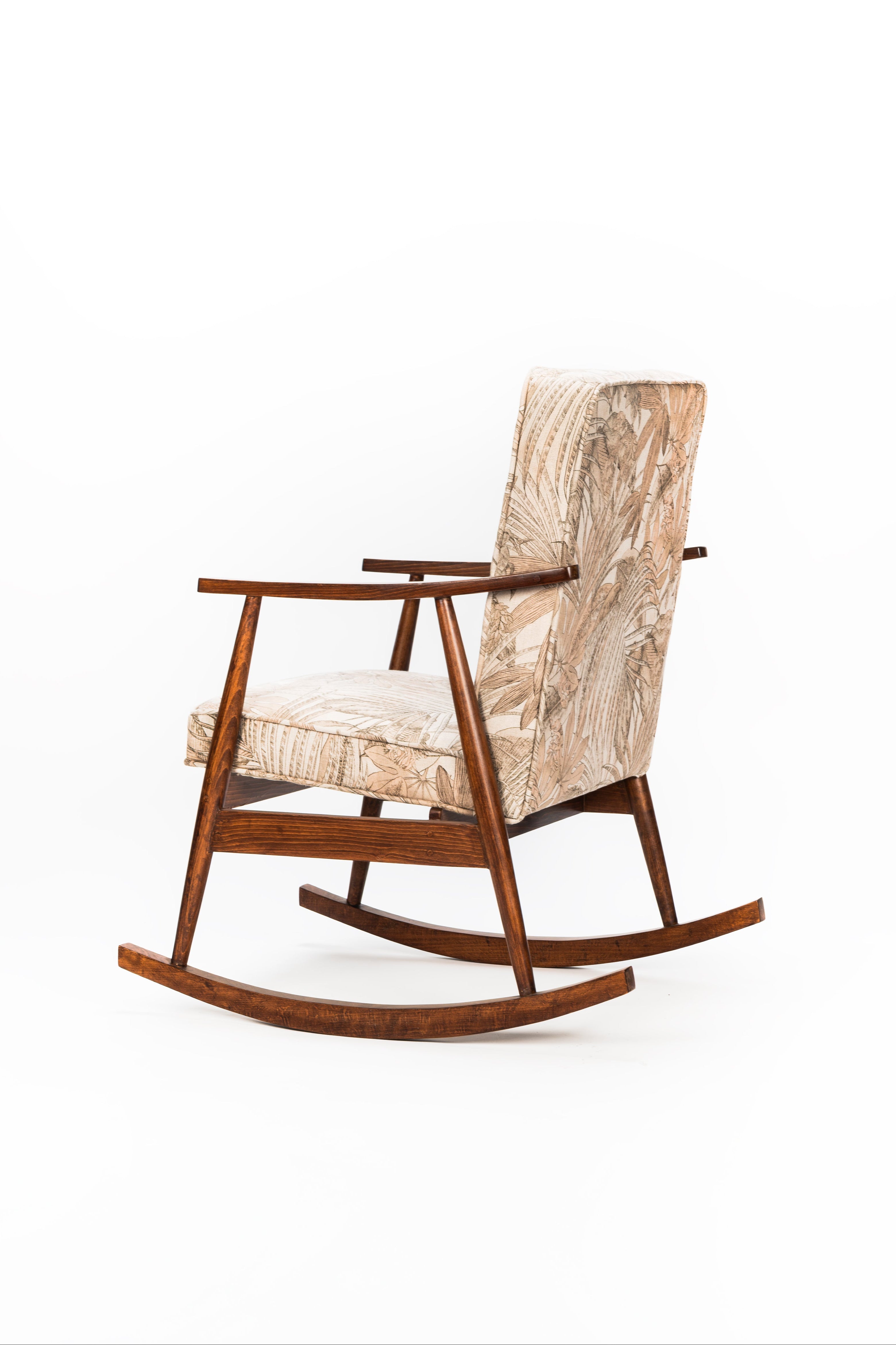 Wooden rocking chair with patterned cushion on a white background