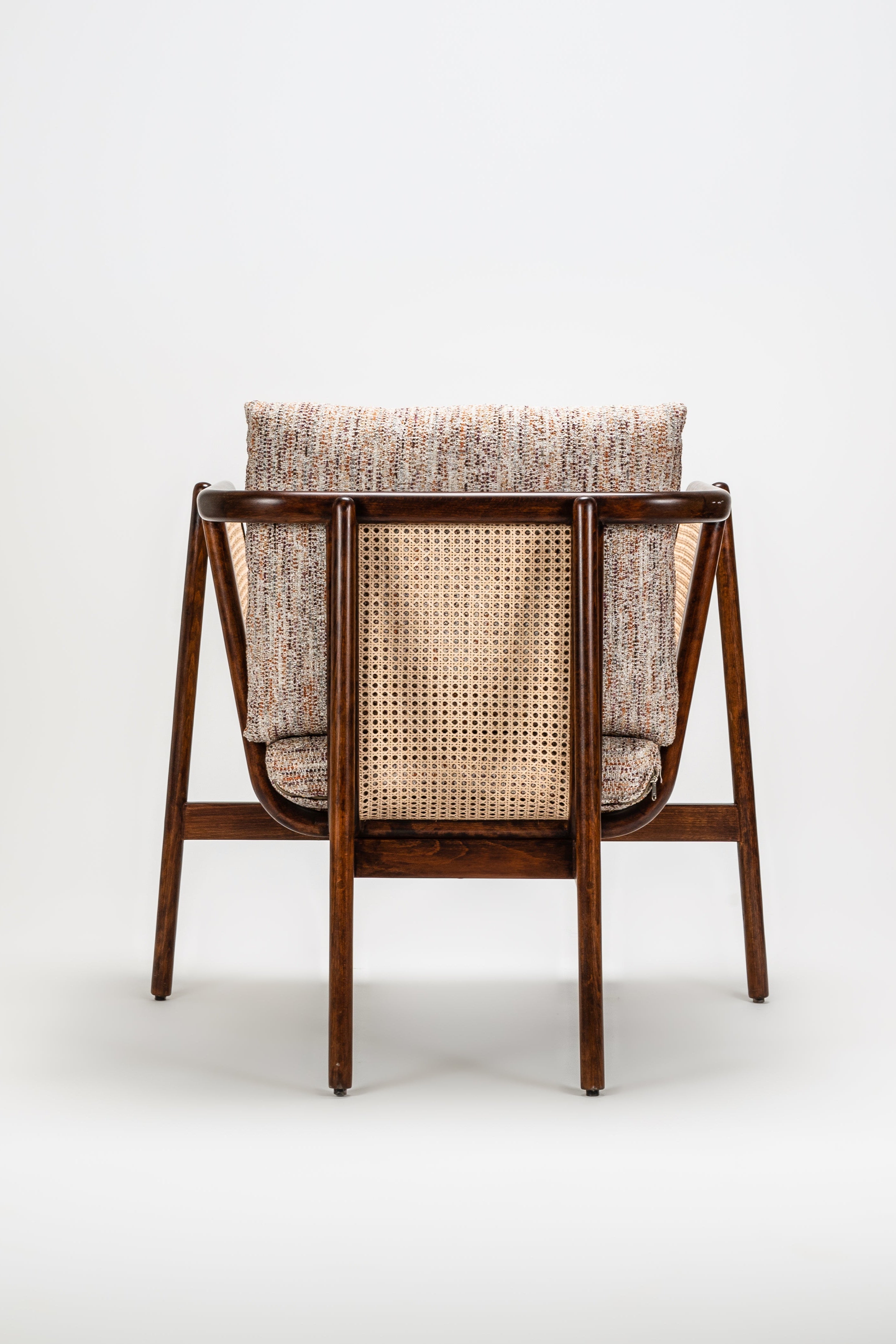 Chair with woven backrest and cushion on a white background