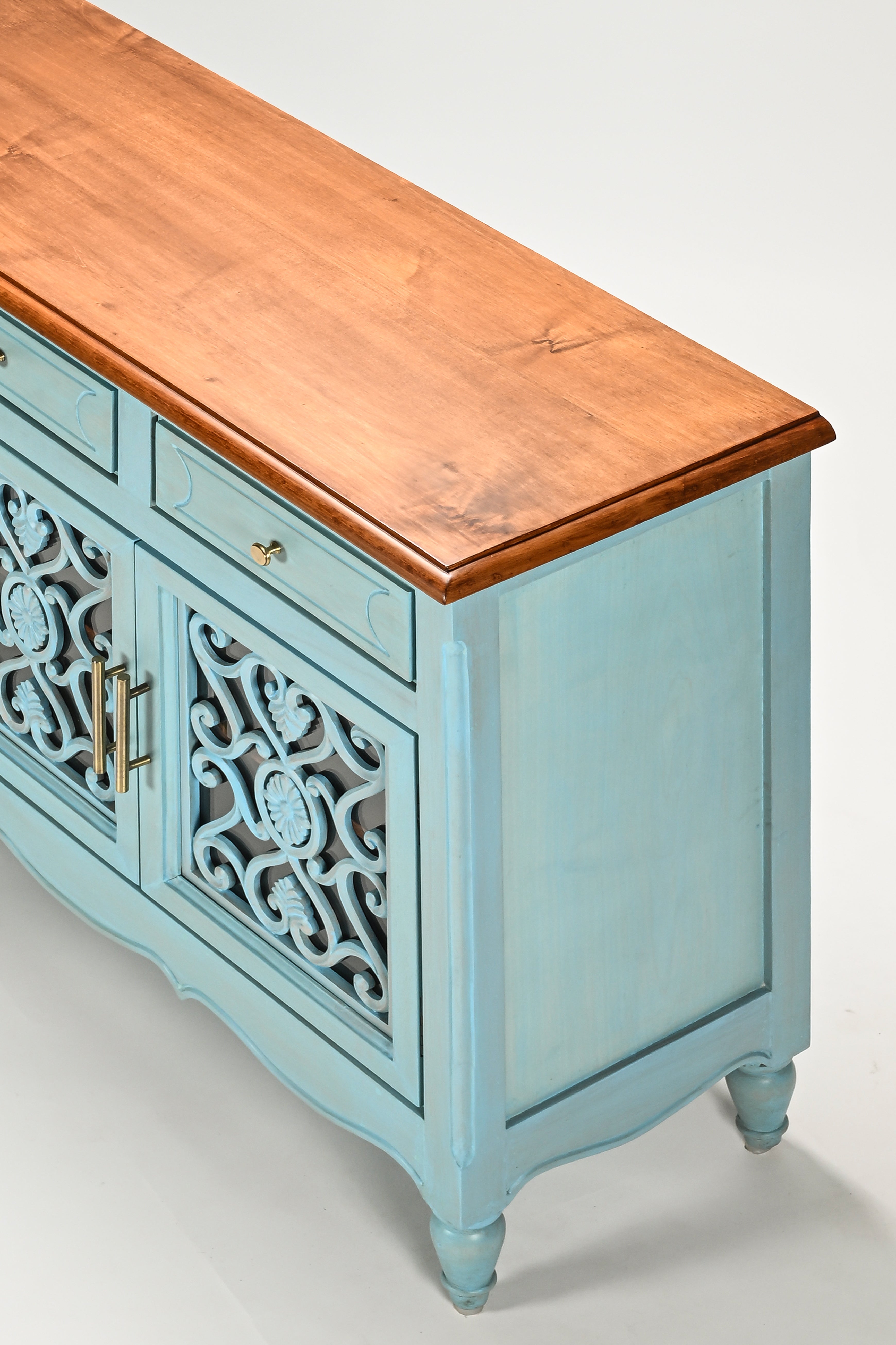 Teal sideboard with wooden top on a white background