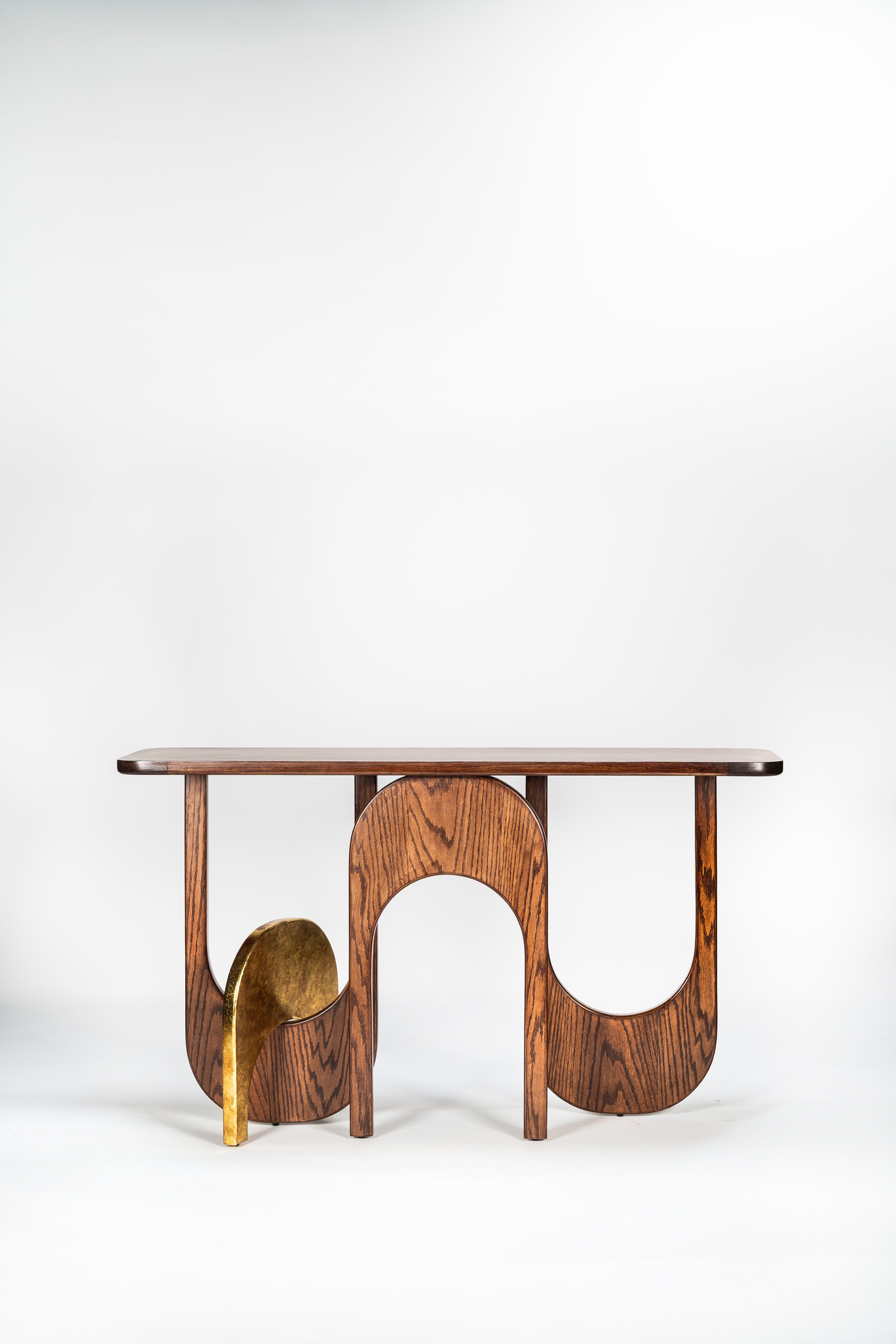 Wooden console table with a brass base on a white background