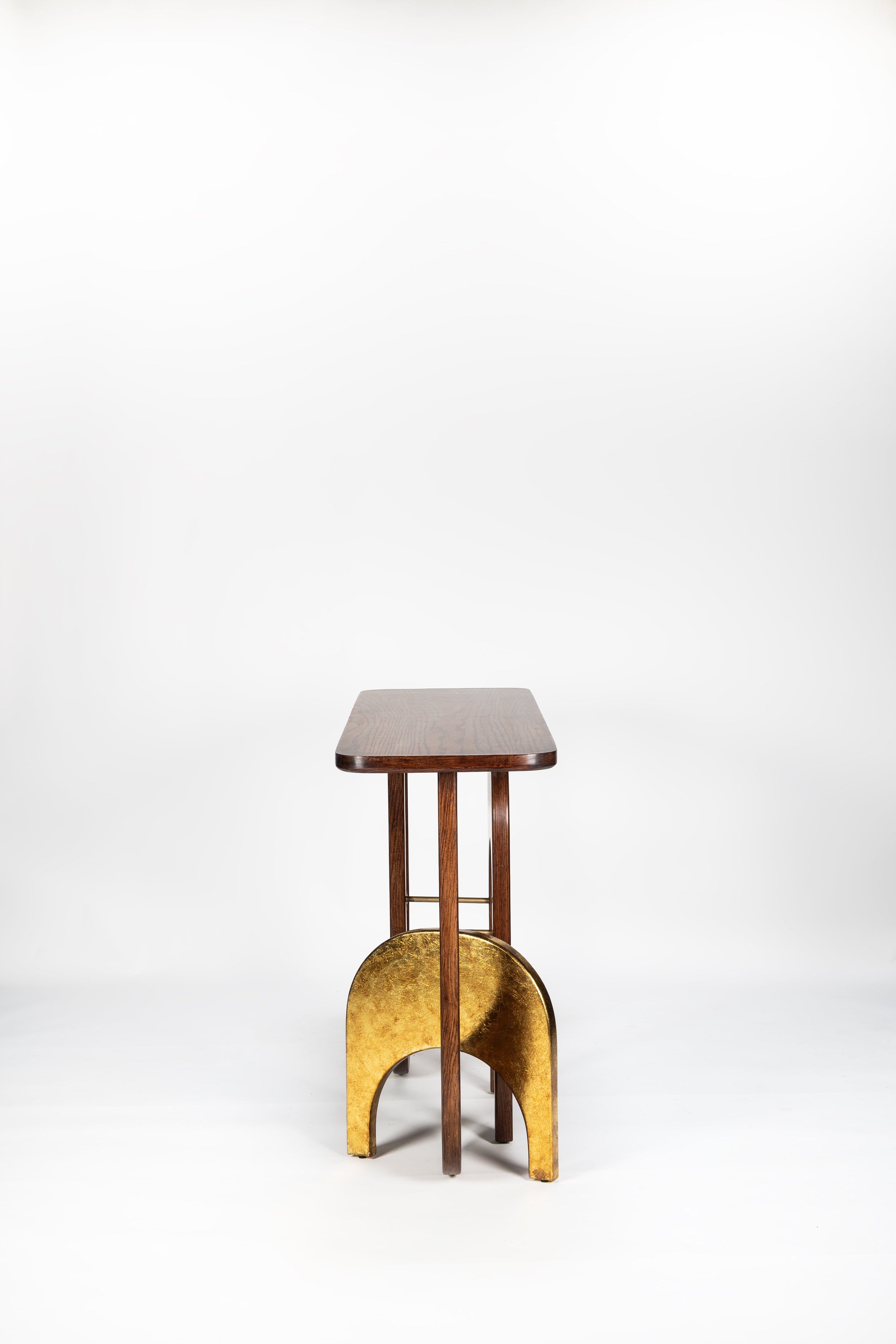 Small wooden stool with a gold base on a white background