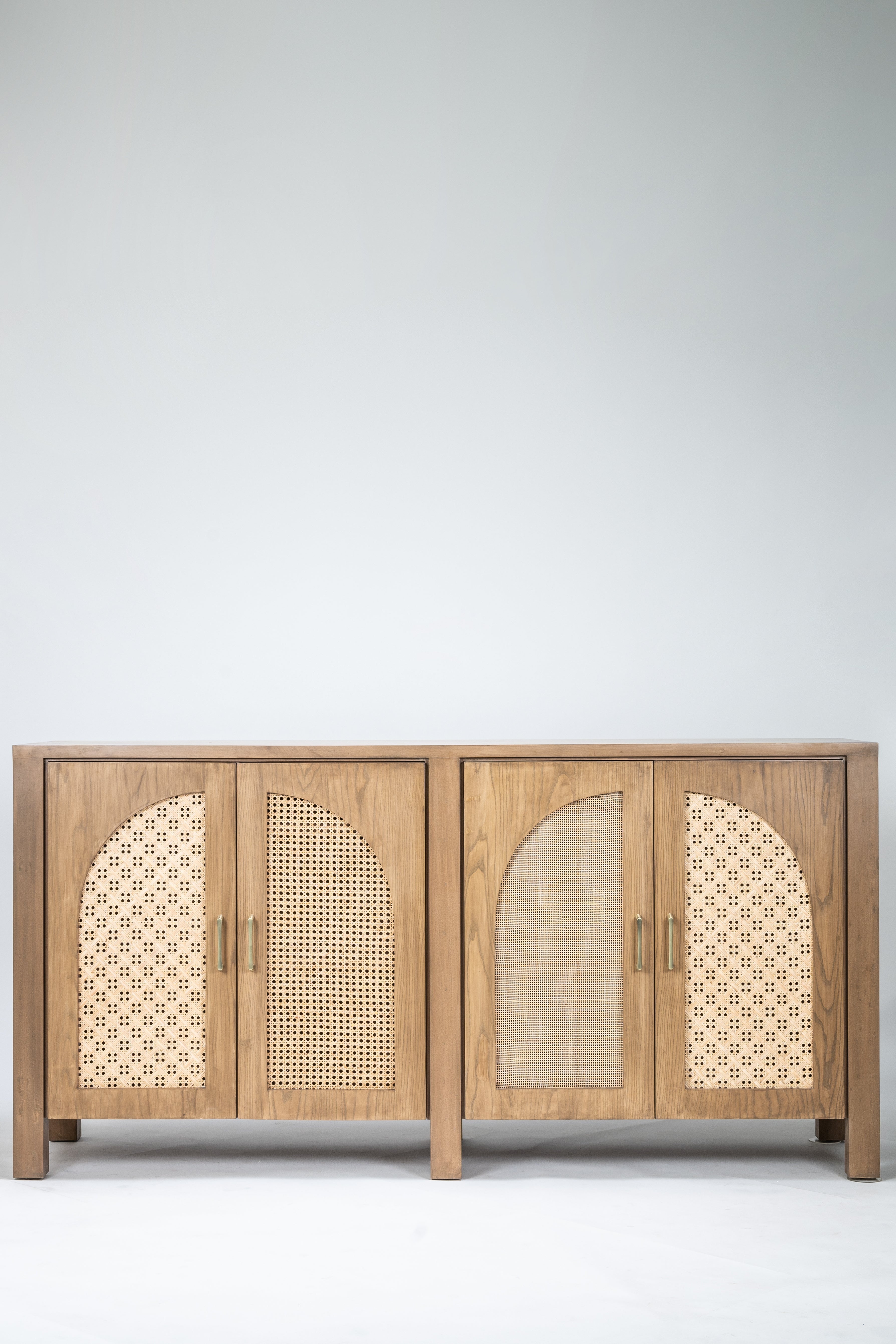 Wooden cabinet with wicker doors on a white background