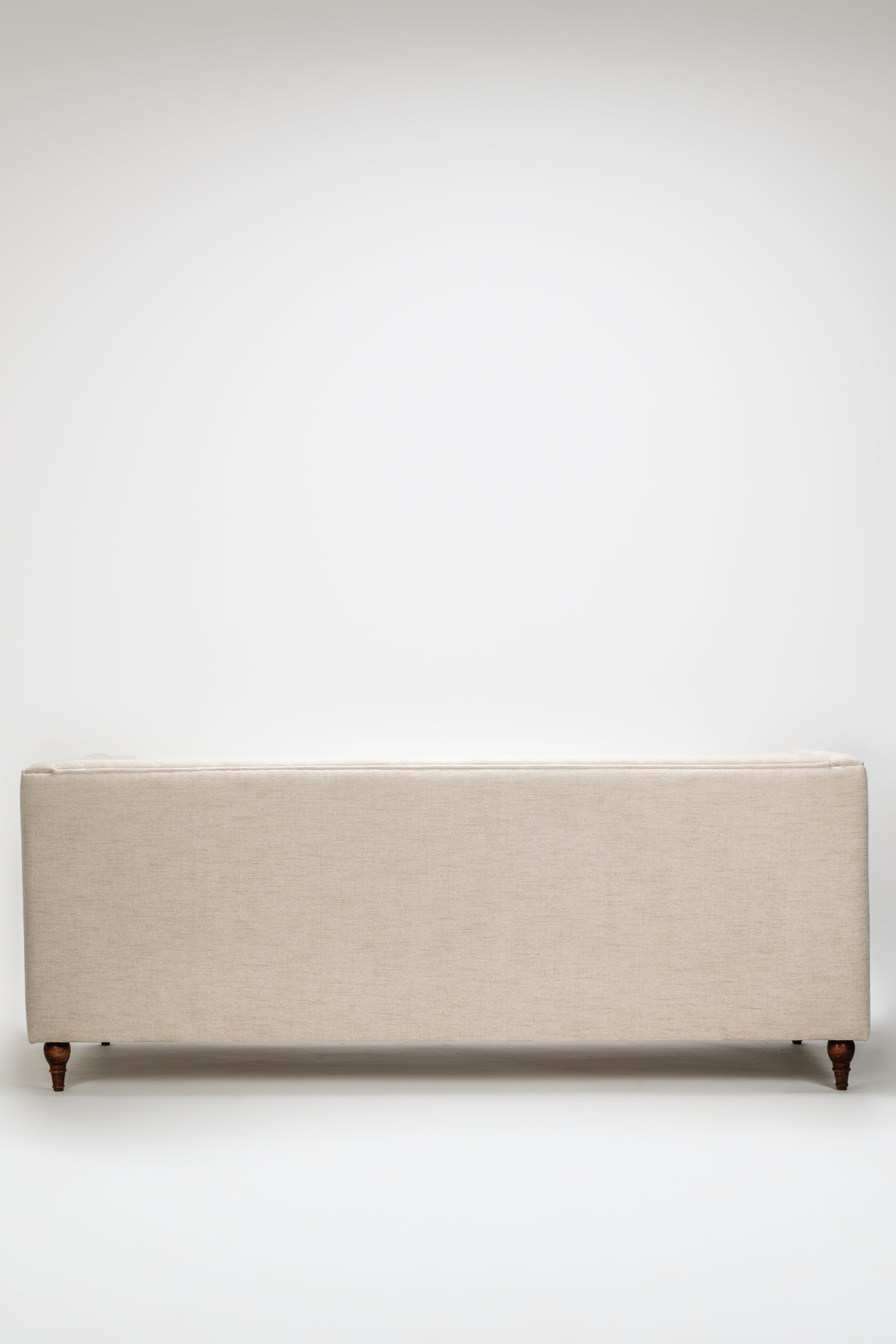 Beige upholstered bench on a white background
