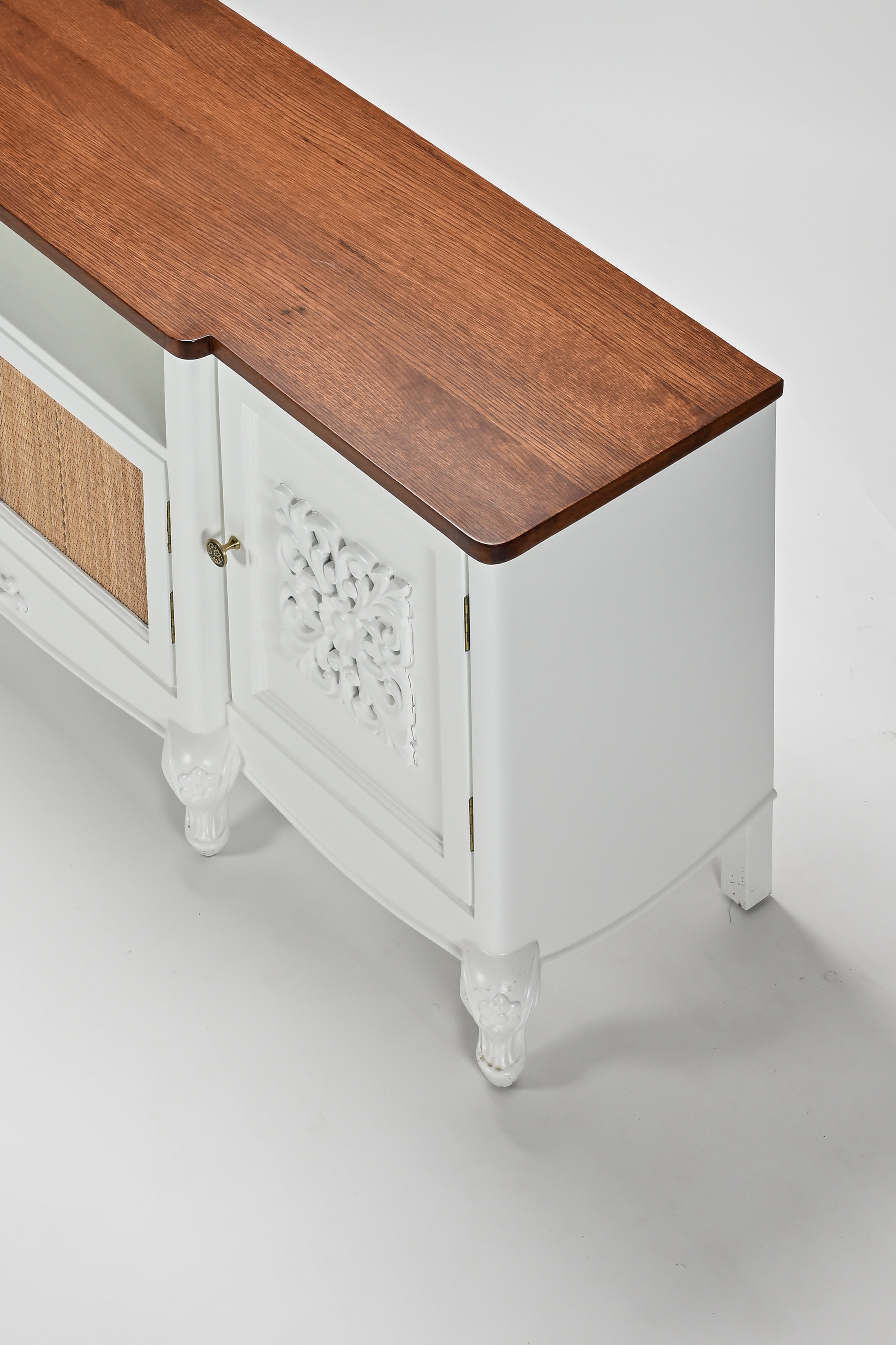 White cabinet with wooden top on a light gray background
