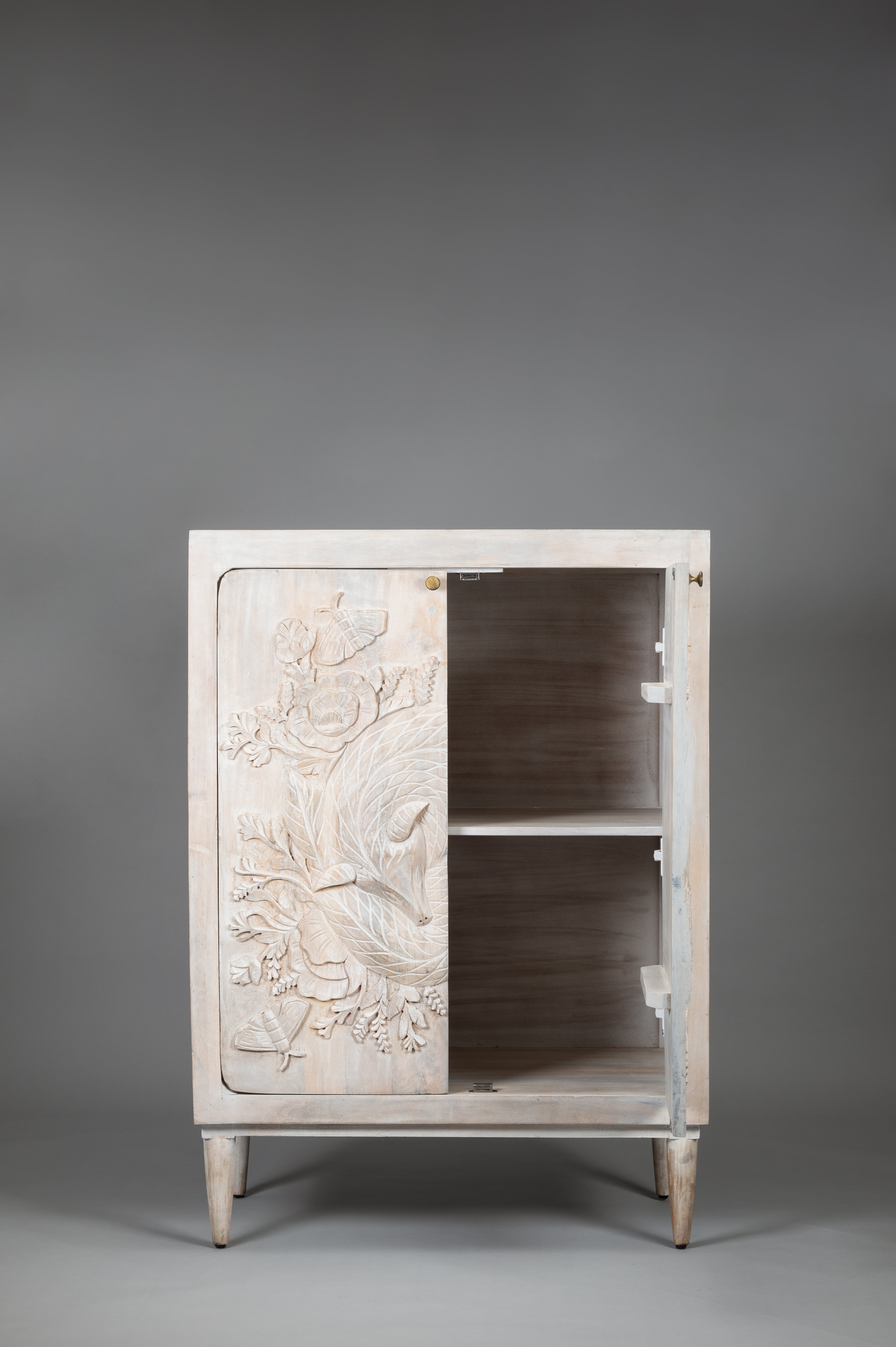 Wooden cabinet with floral carvings on a gray background
