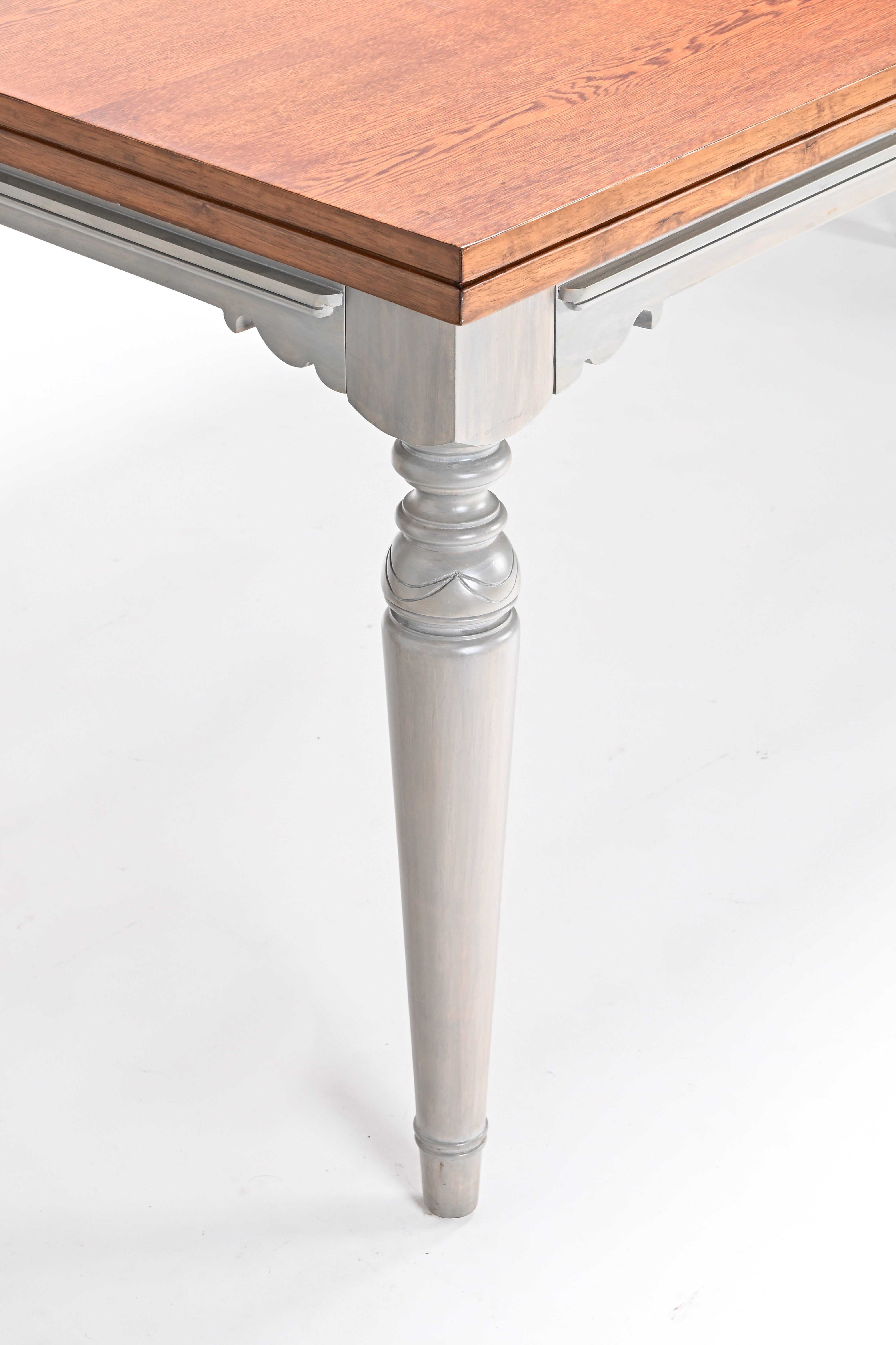 Table with wooden top and white legs on a white background