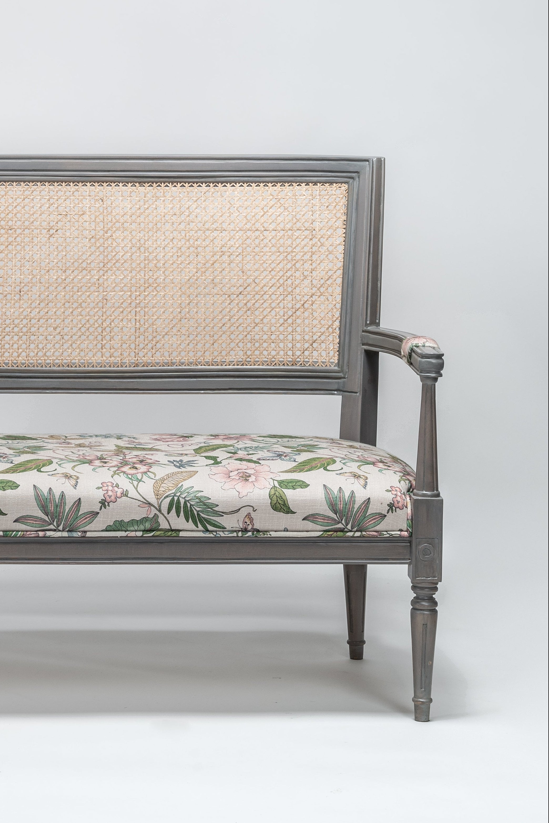 Decorative bench with floral cushion on a white background