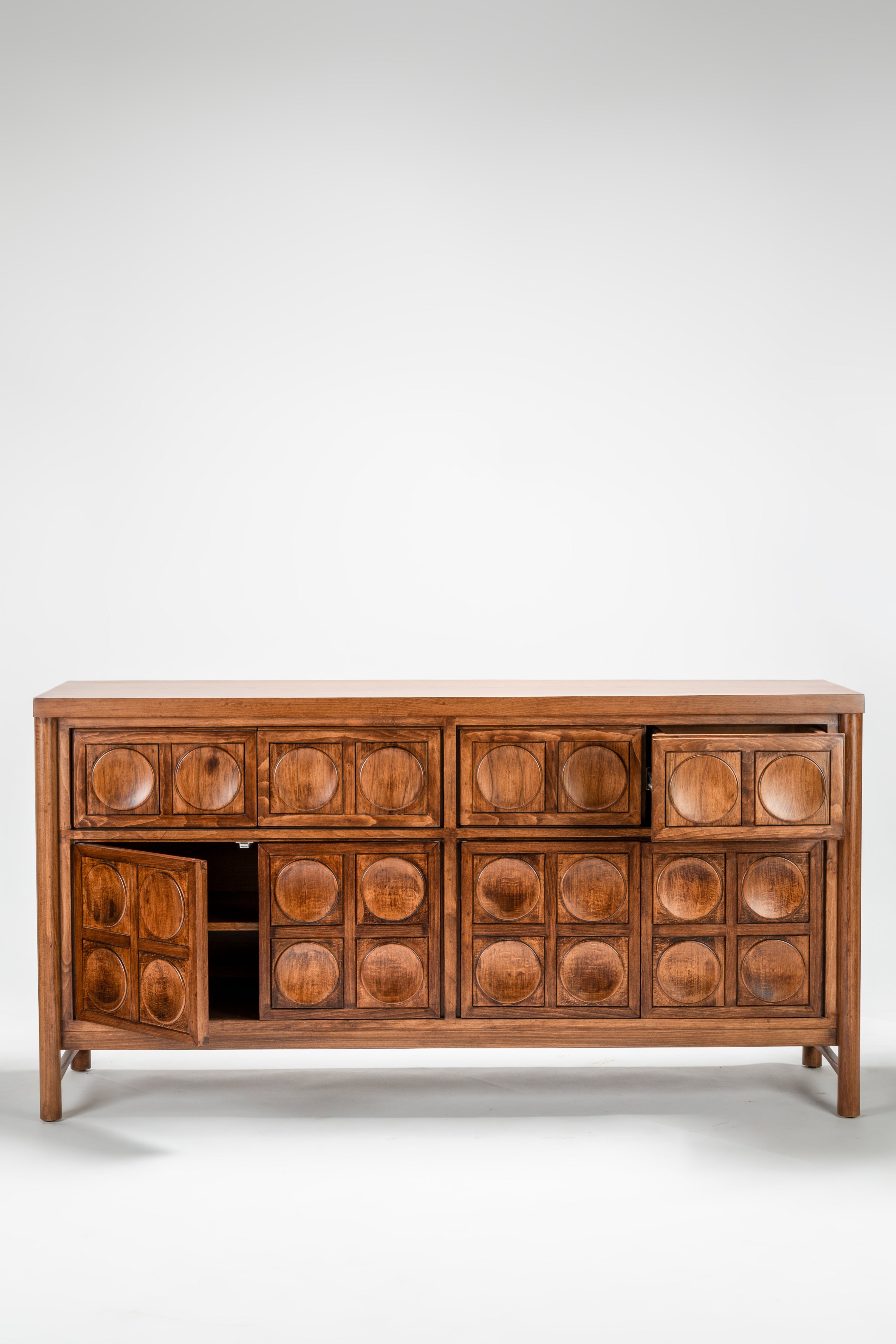 Wooden sideboard with circular patterns on a white background