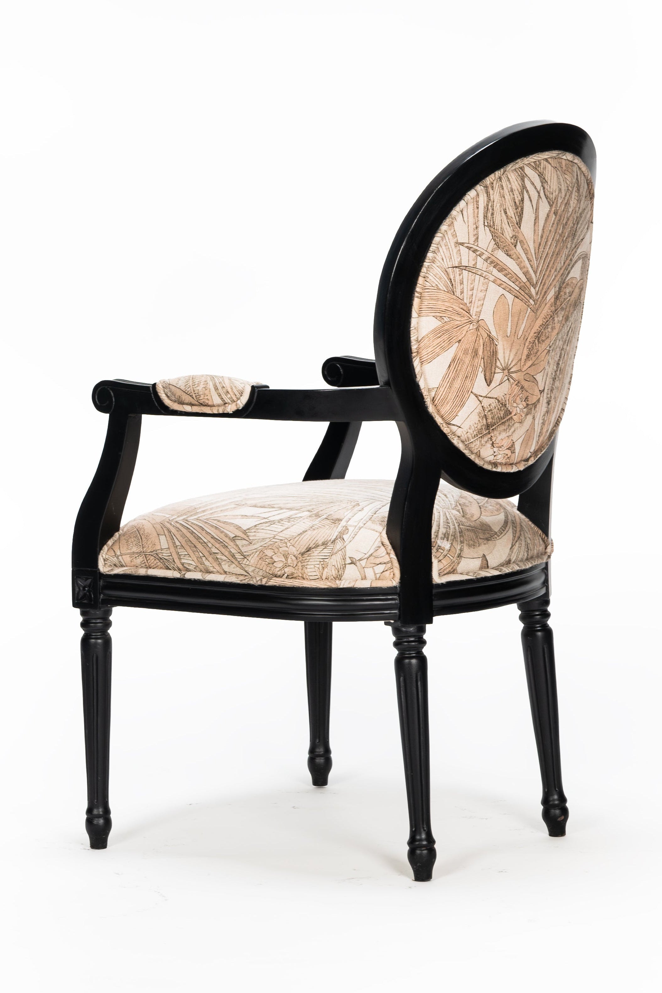 Decorative armchair with black frame and beige cushion on a white background