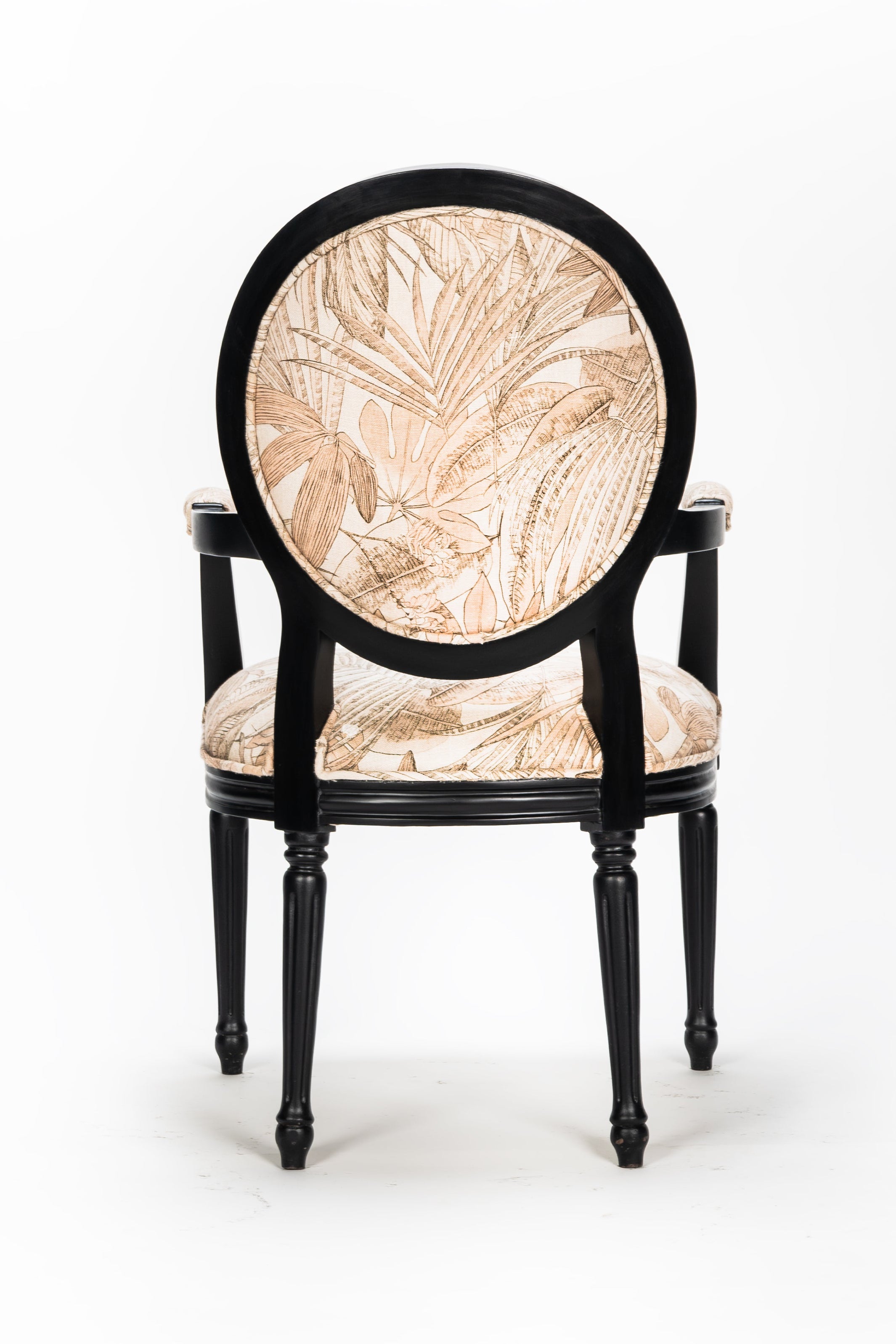Decorative chair with black frame and beige floral pattern on a white background