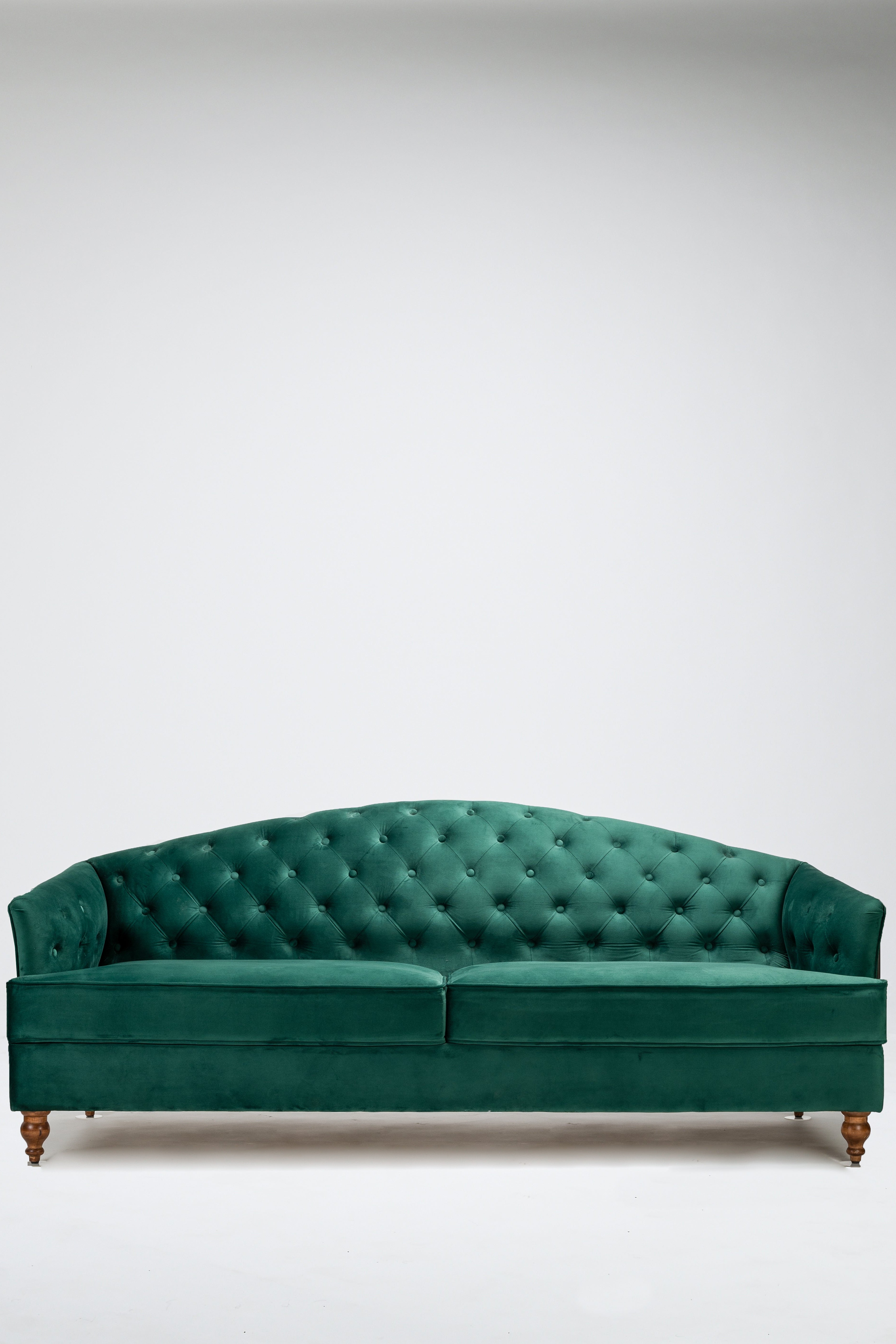 Green velvet sofa on a white background