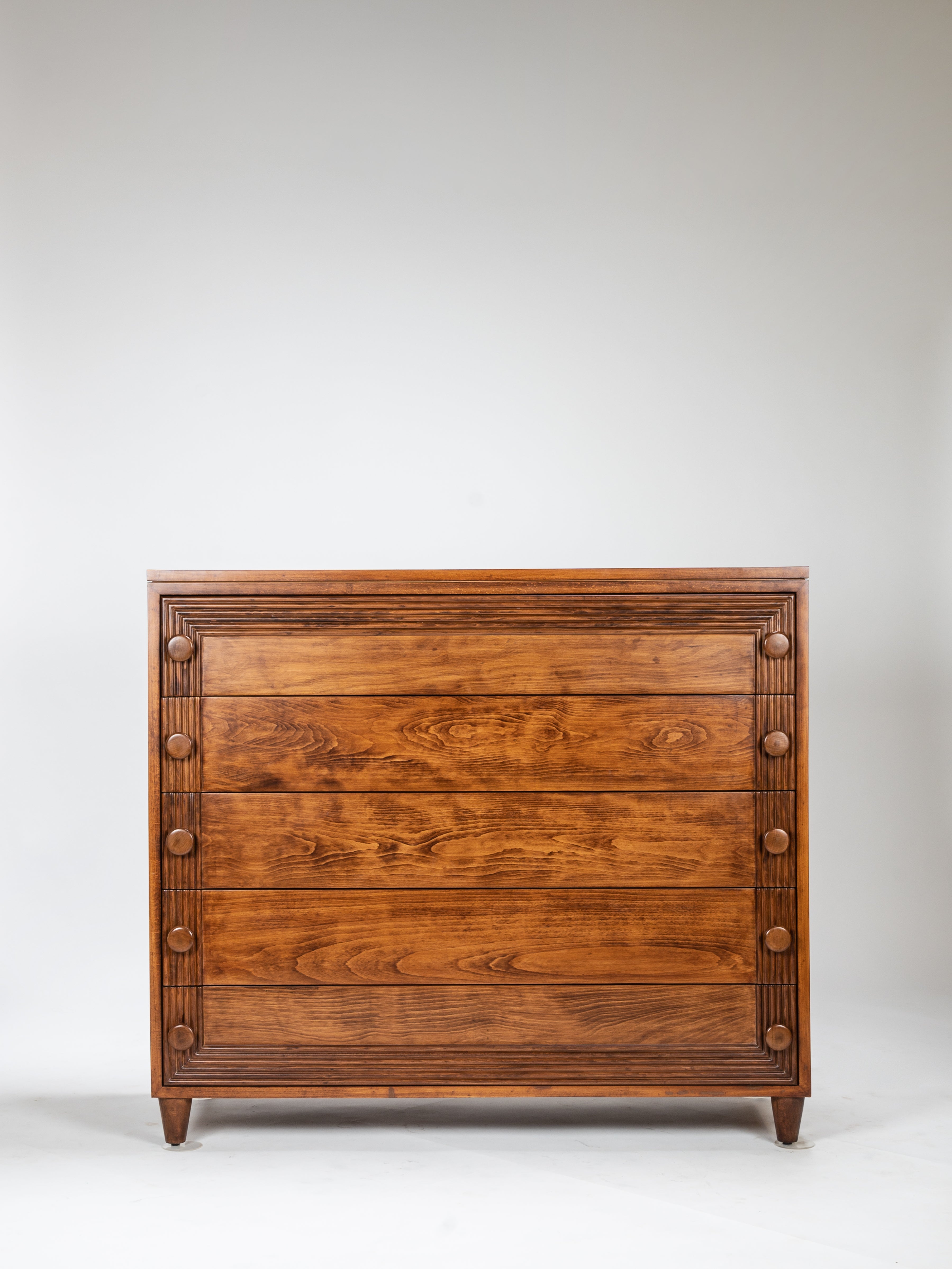 Wooden dresser with three drawers on a white background