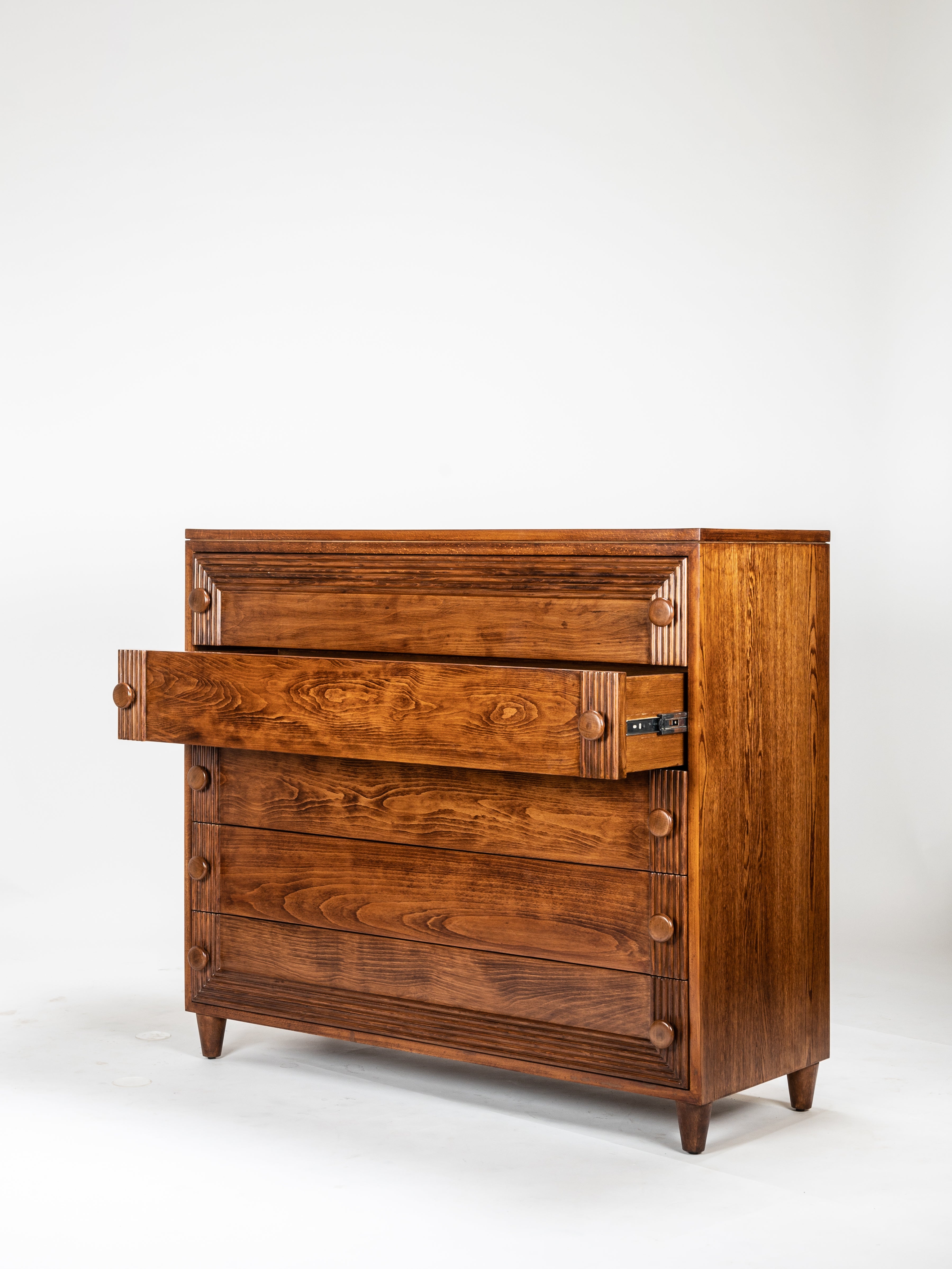 Wooden dresser with open drawer on a white background