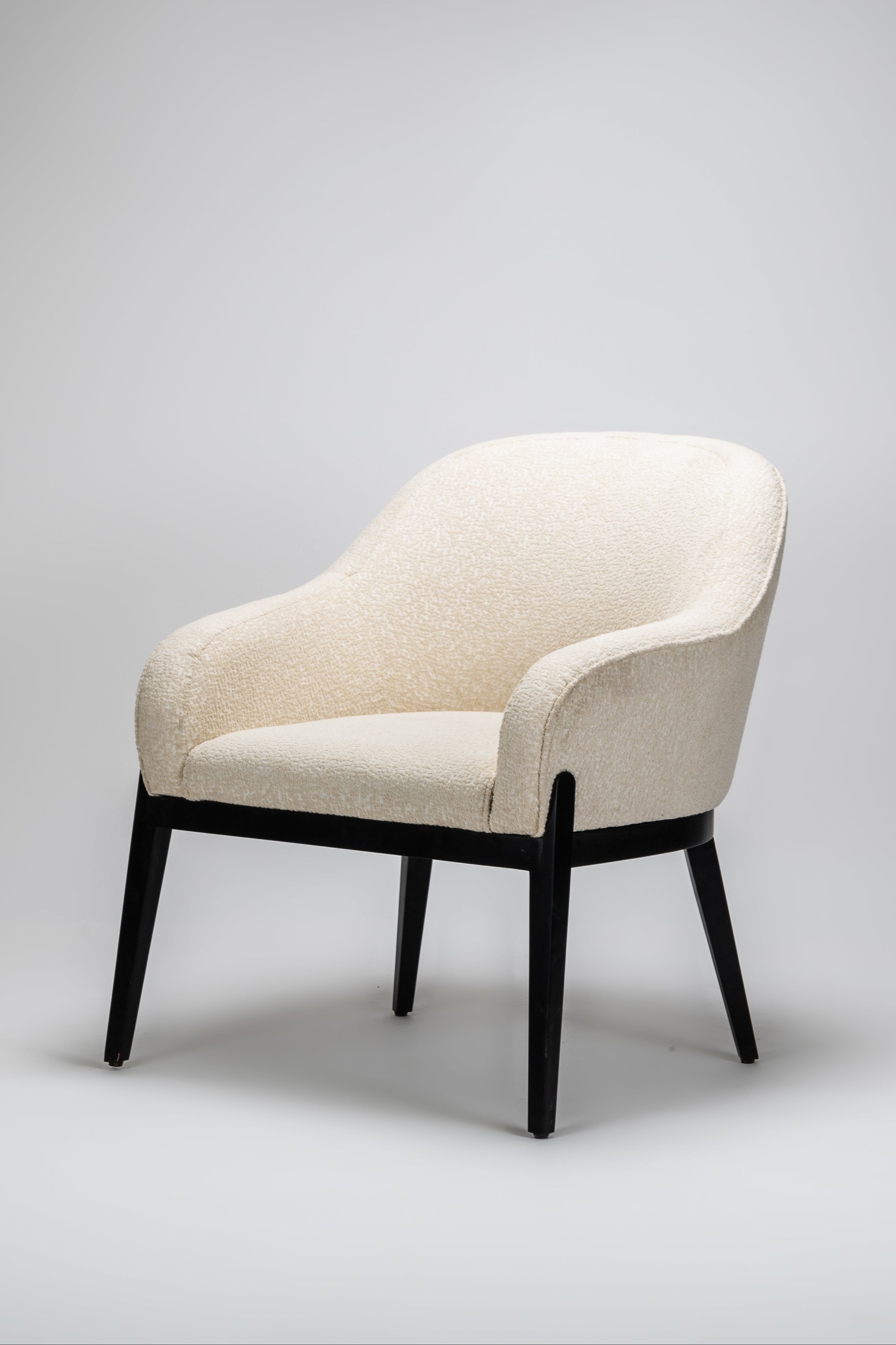 Beige armchair with black legs on a gray background