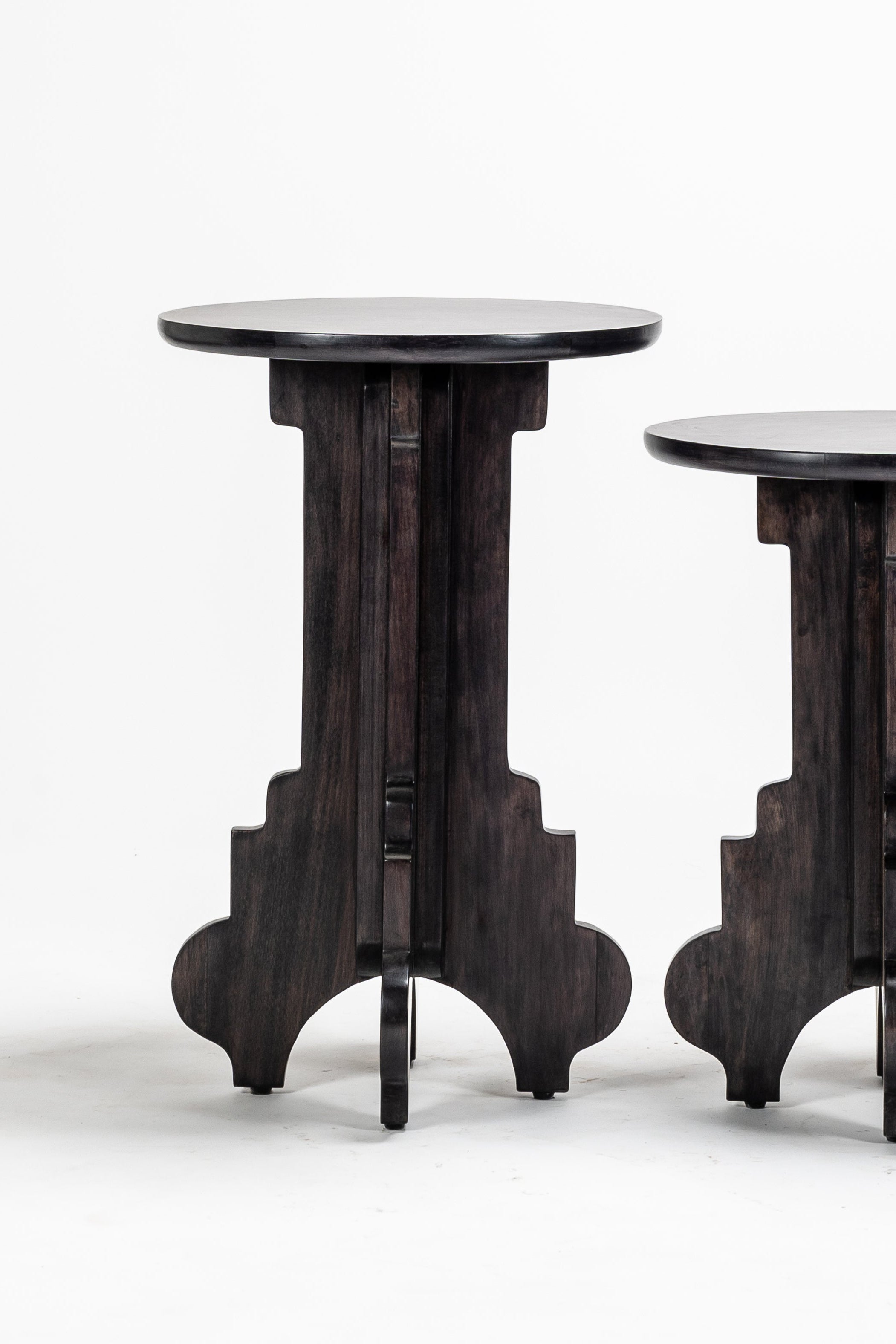 Two dark wooden side tables on a white background