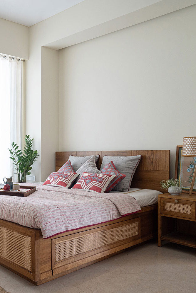 Modern bedroom with wooden bed and side table, light-colored walls, and large window.