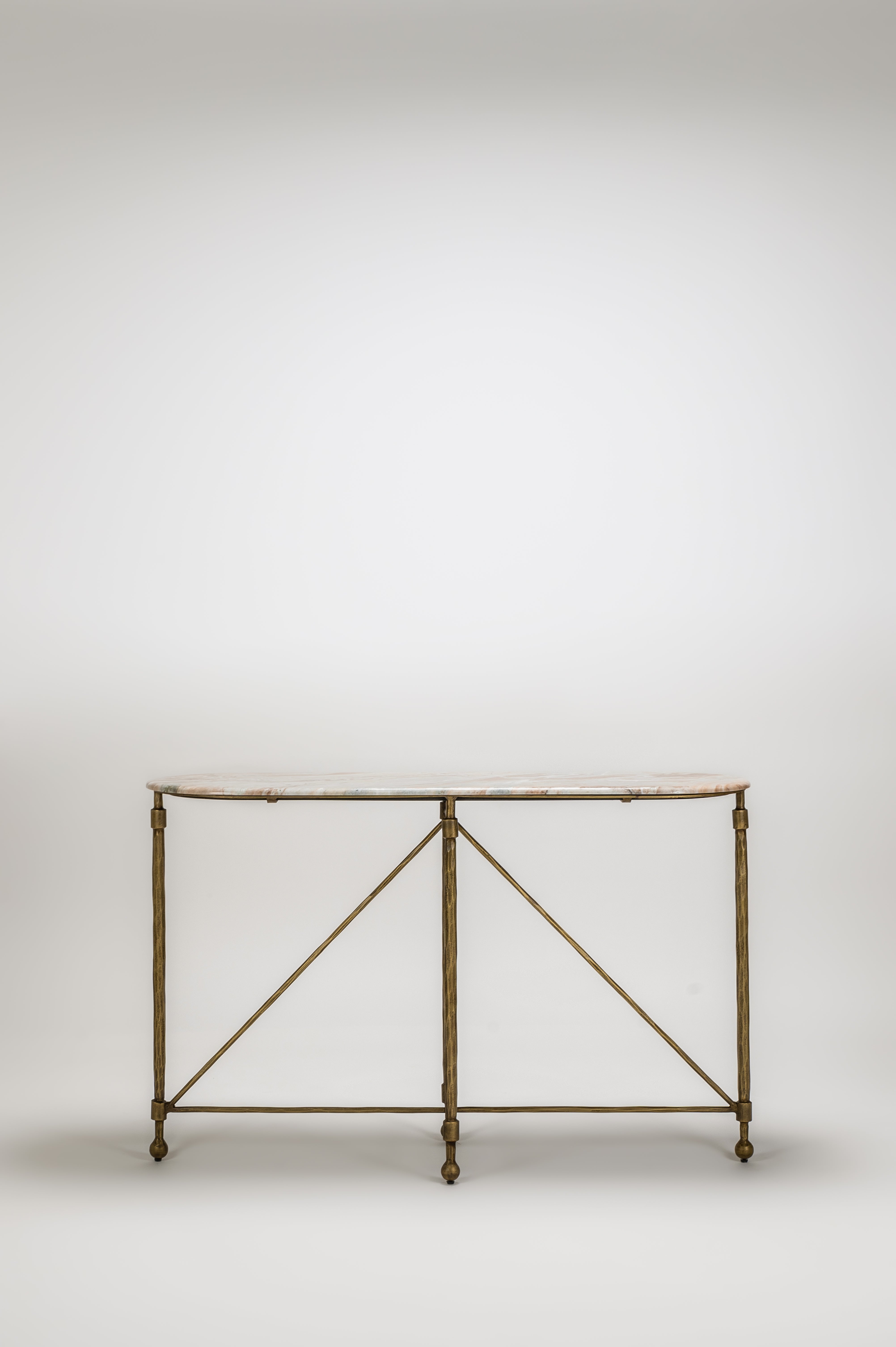 Bronze console table with marble top on a white background