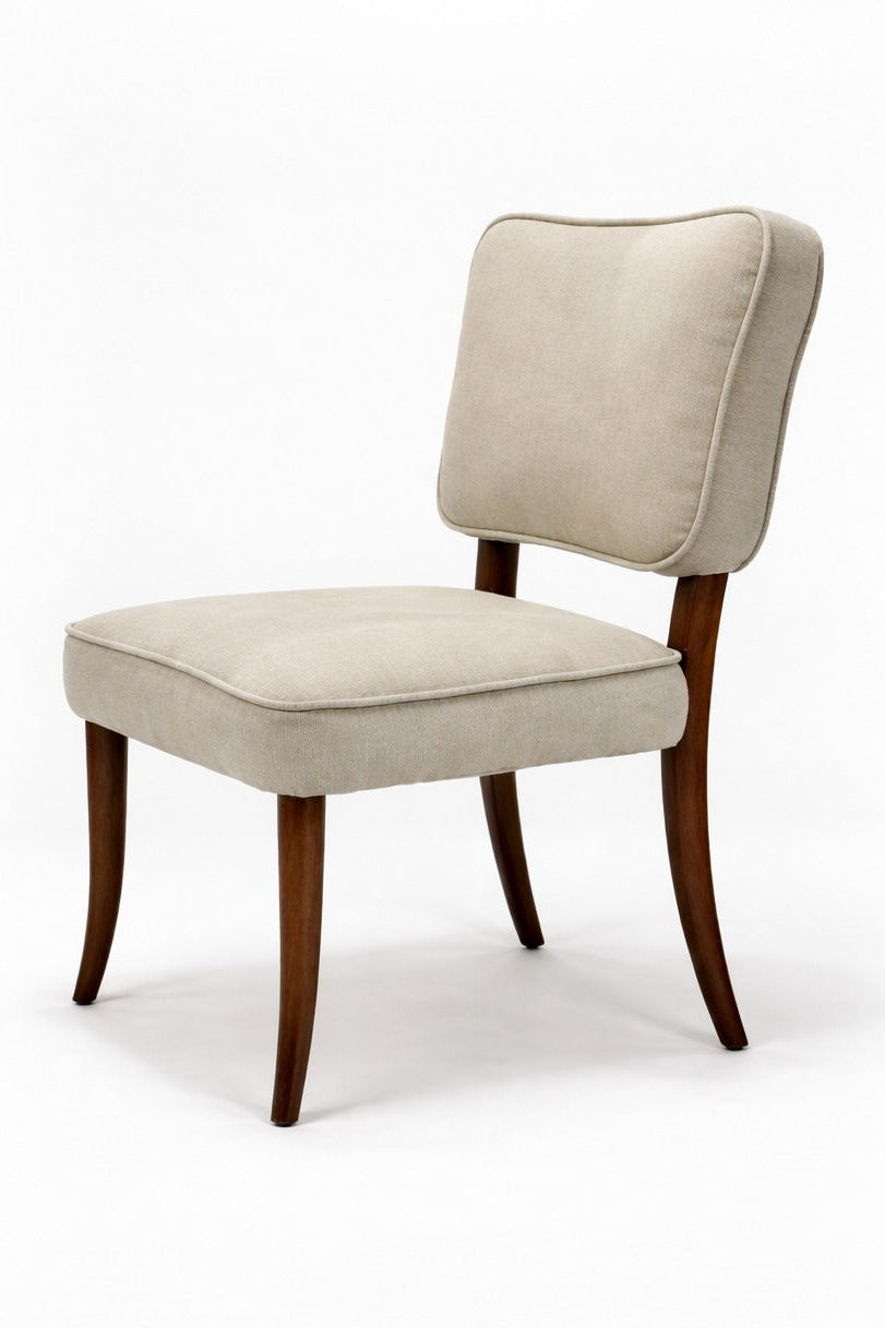 Beige upholstered chair with wooden legs on a white background