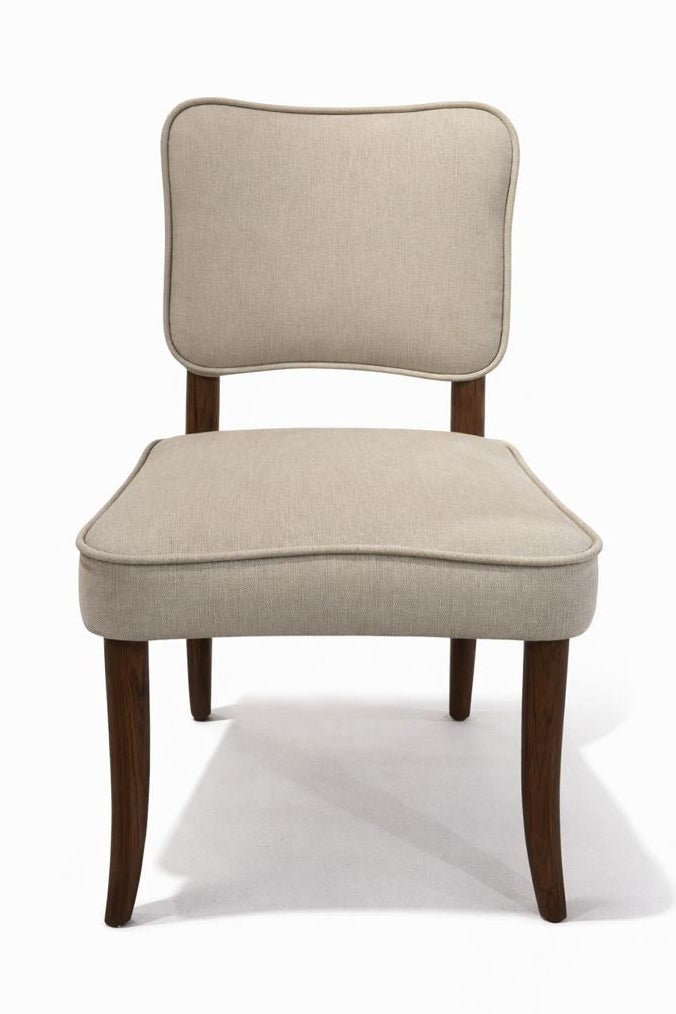 Beige upholstered chair with wooden legs on a white background