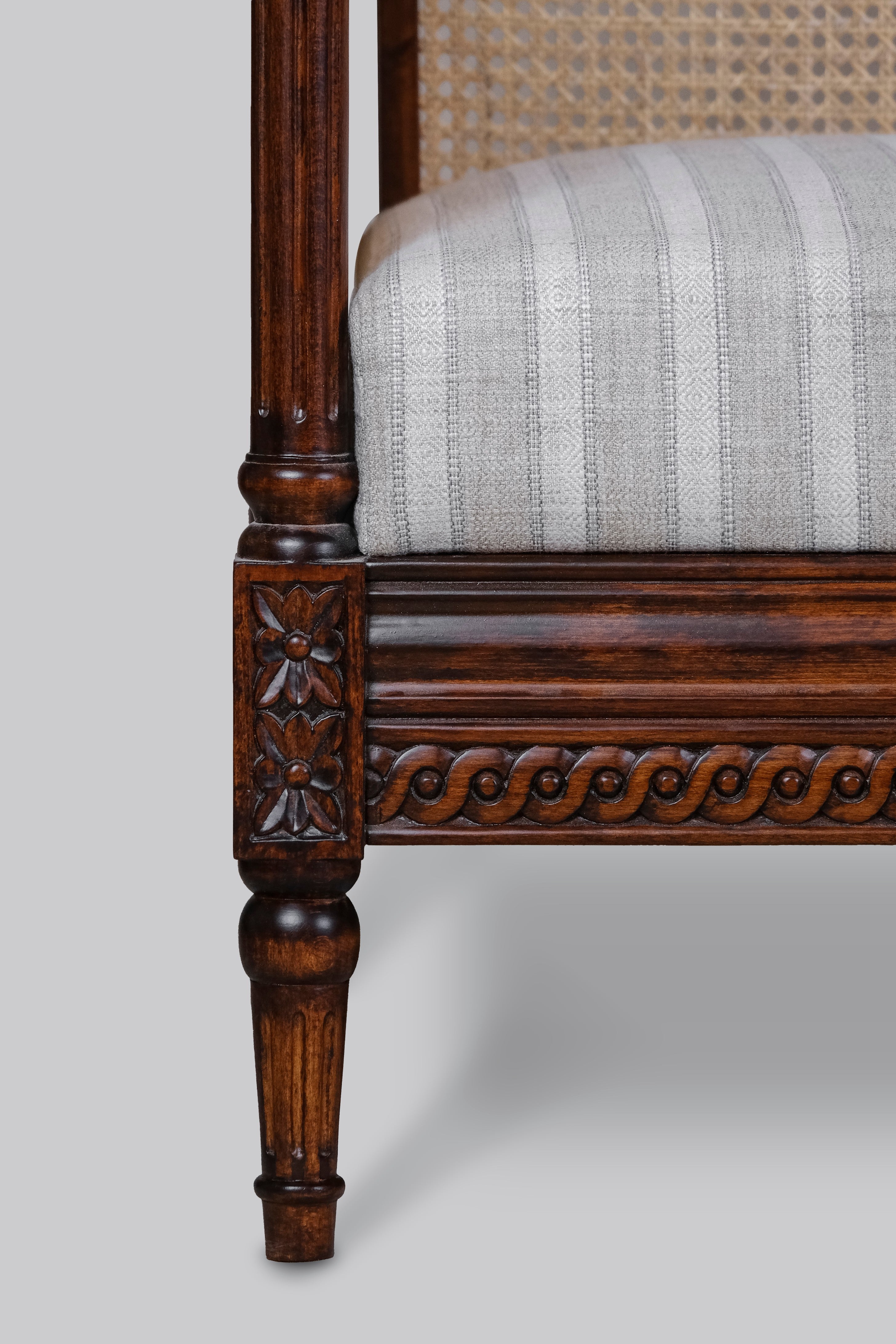 Chair with wooden frame and striped fabric seat on a gray background
