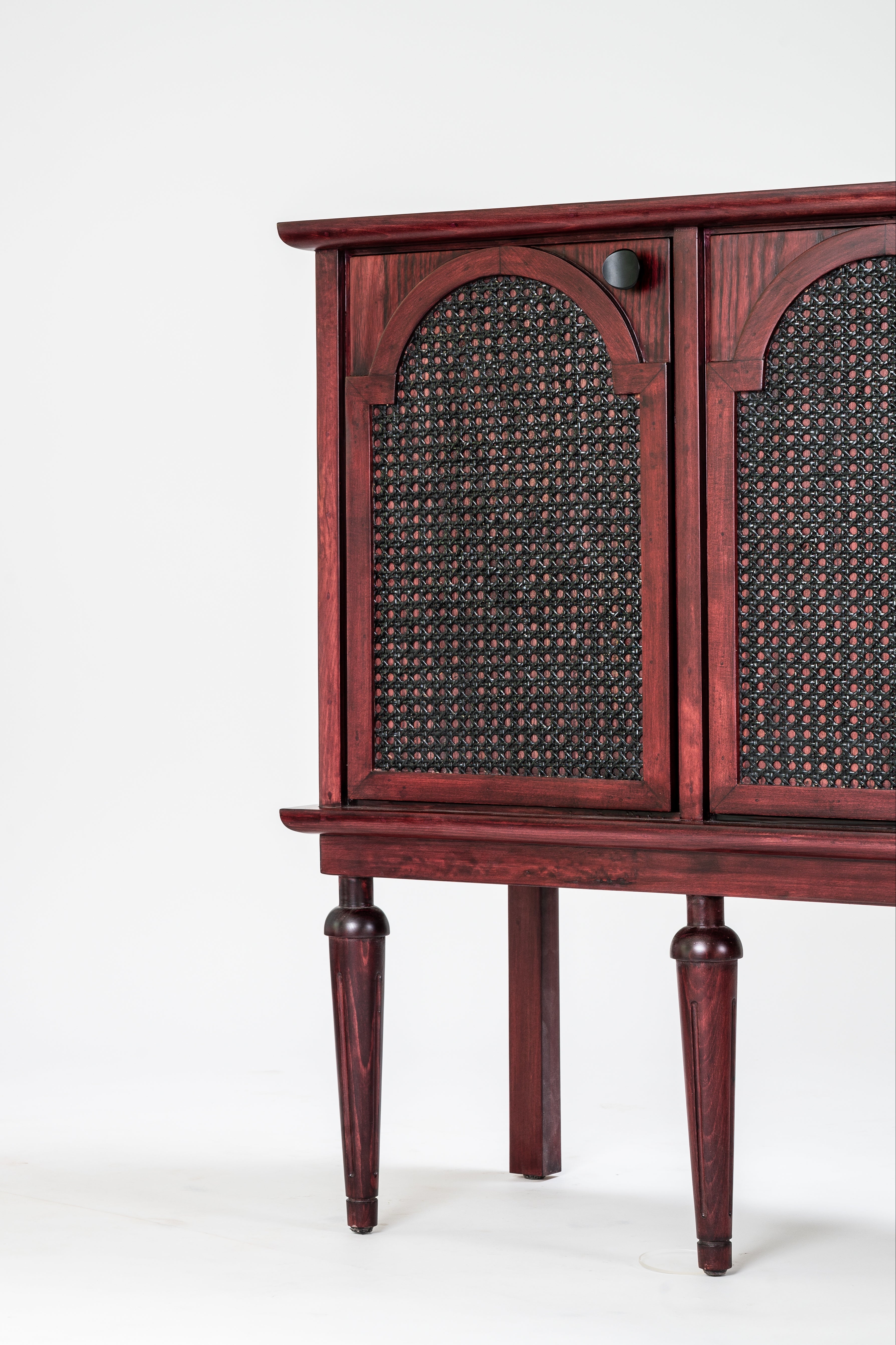 Wooden cabinet with wicker doors on a white background