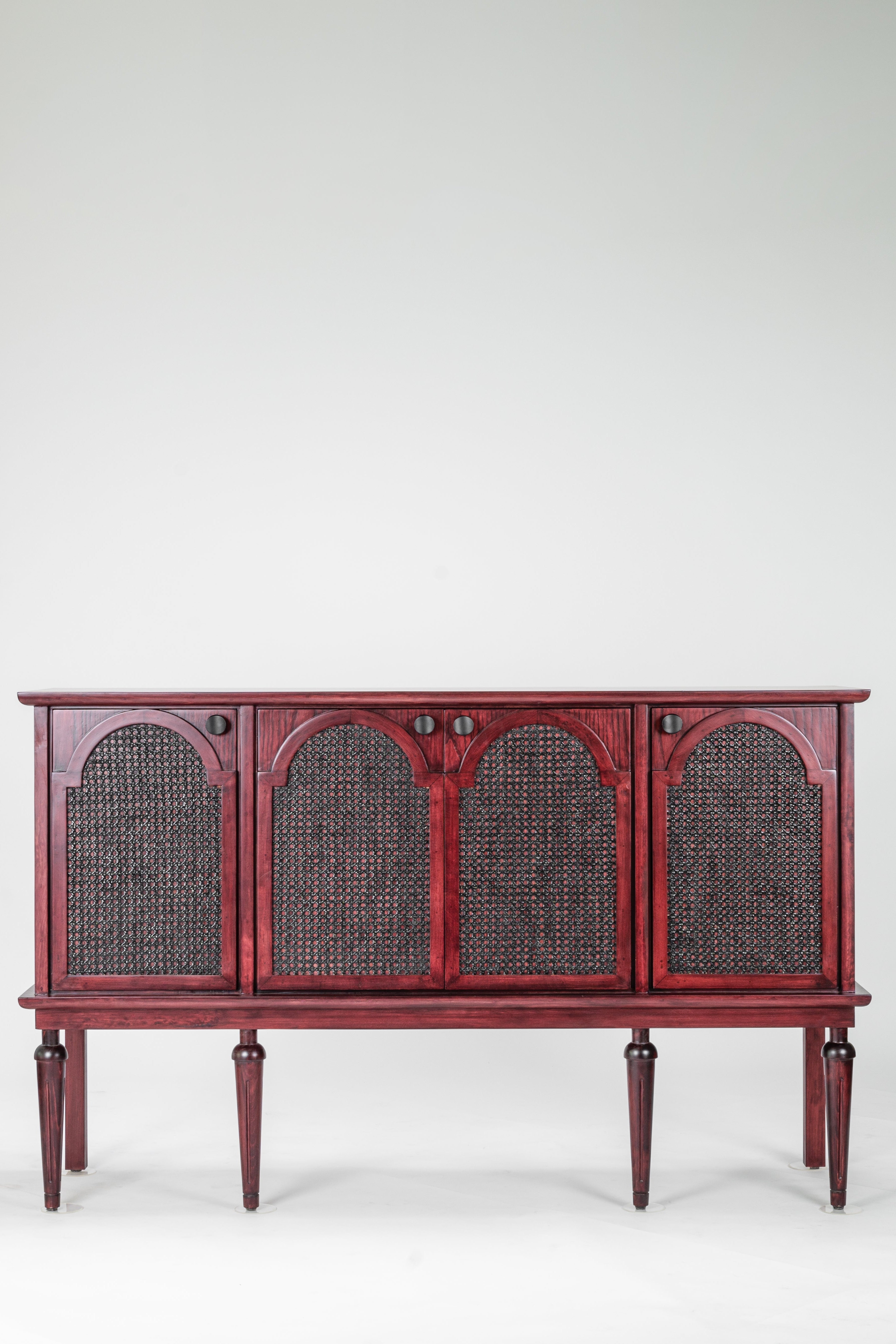 Red wooden sideboard with wicker panels on a white background