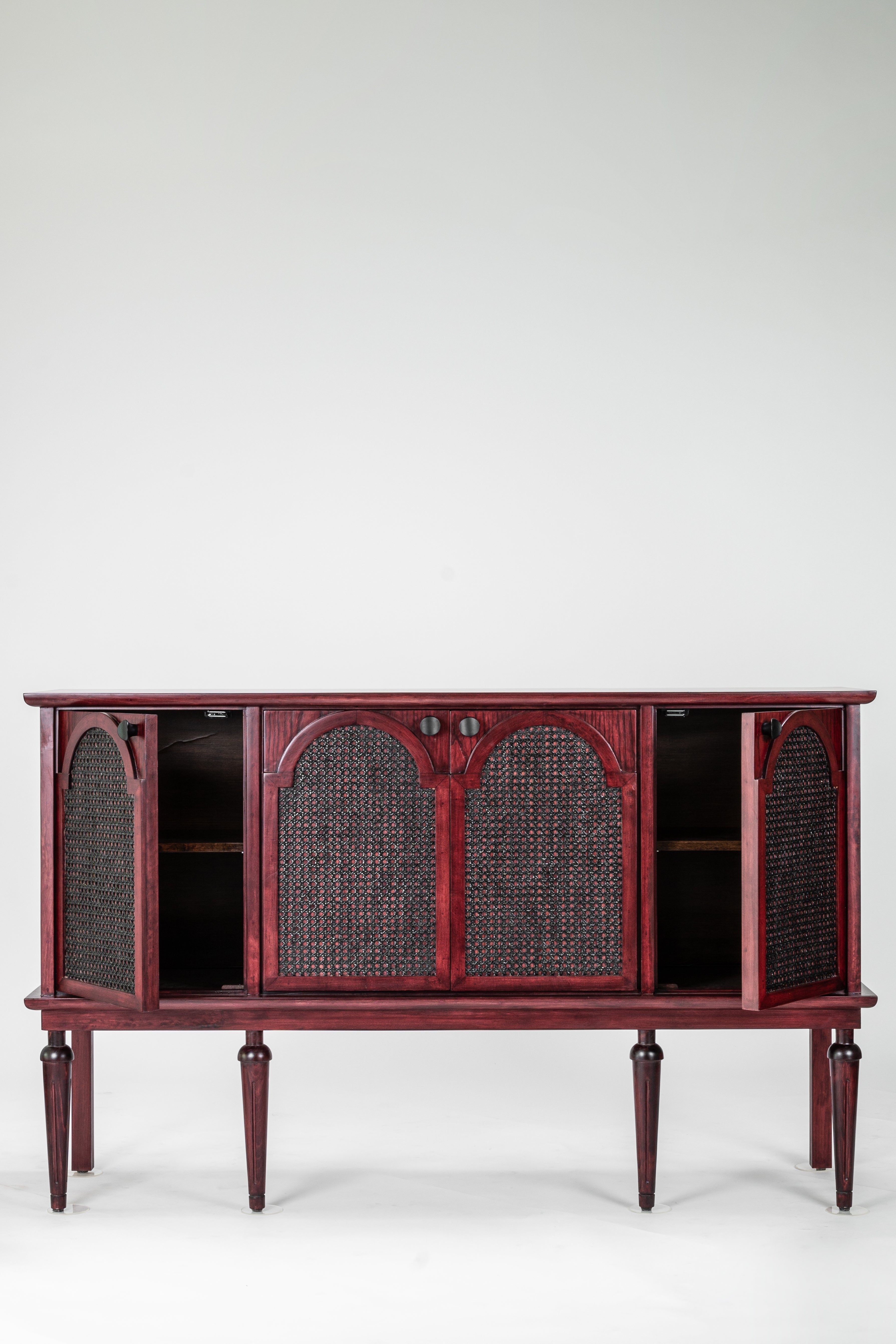 Wooden sideboard with wicker panels on a white background