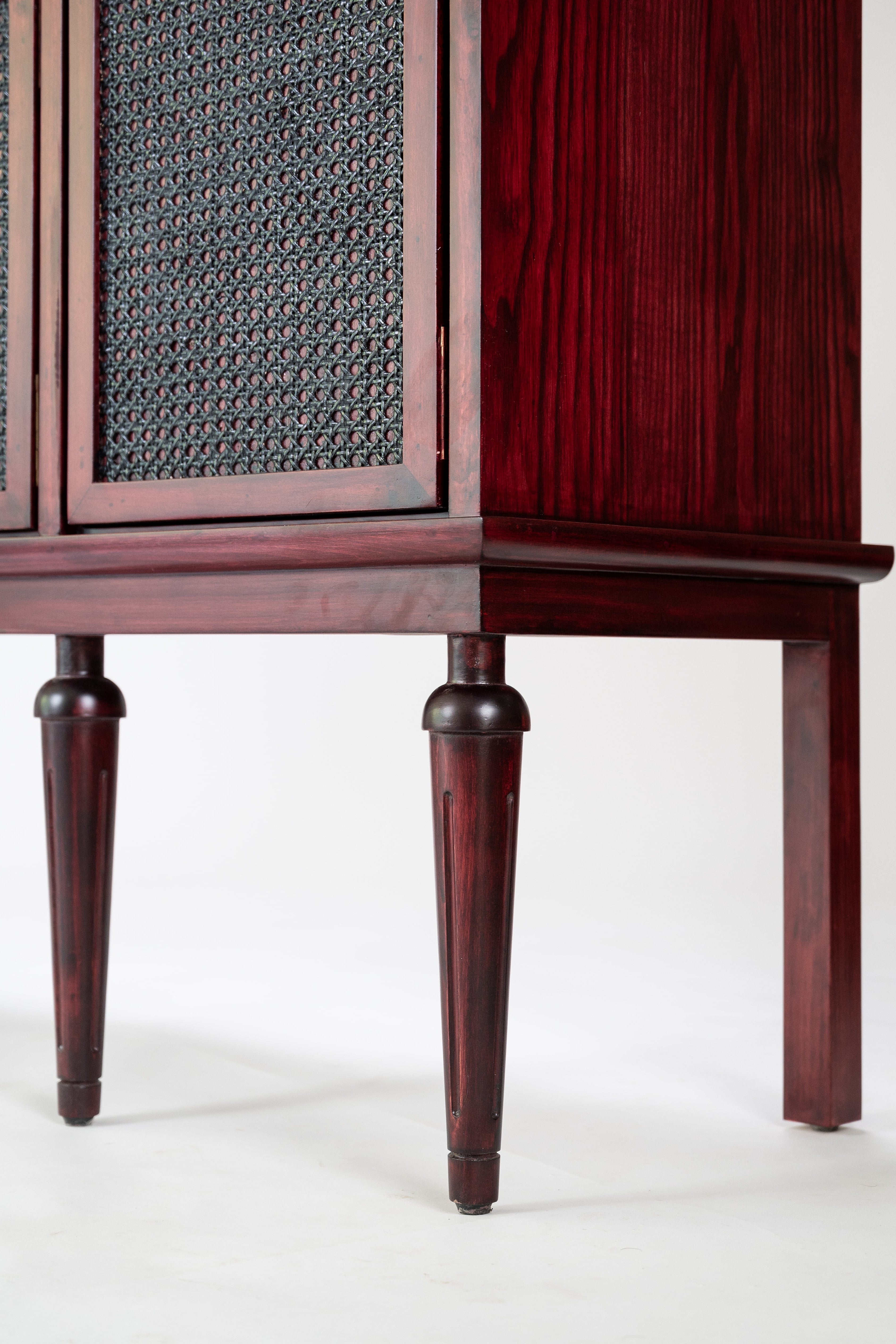 Wooden cabinet with textured doors on a white background