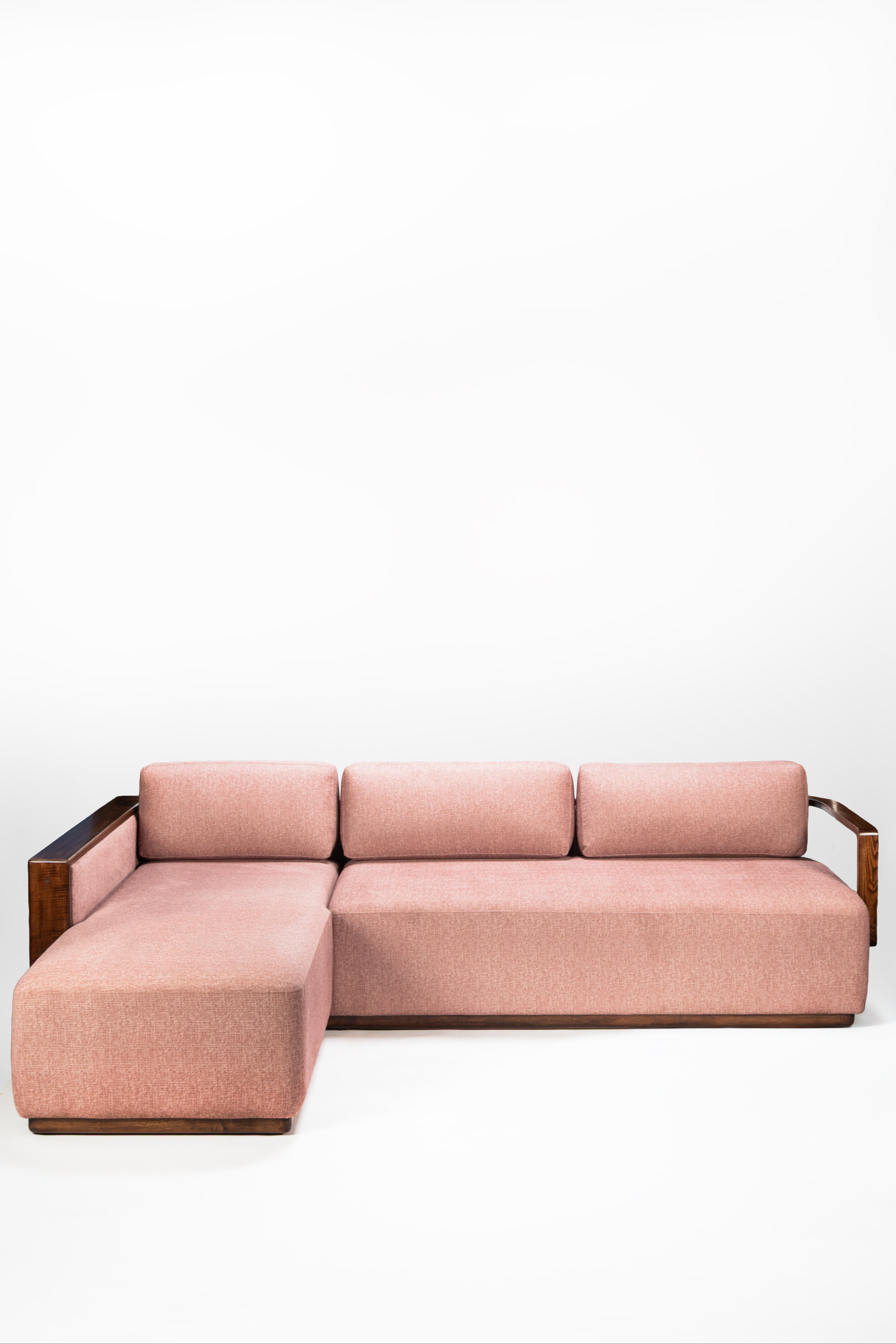 Pink sectional sofa on a white background