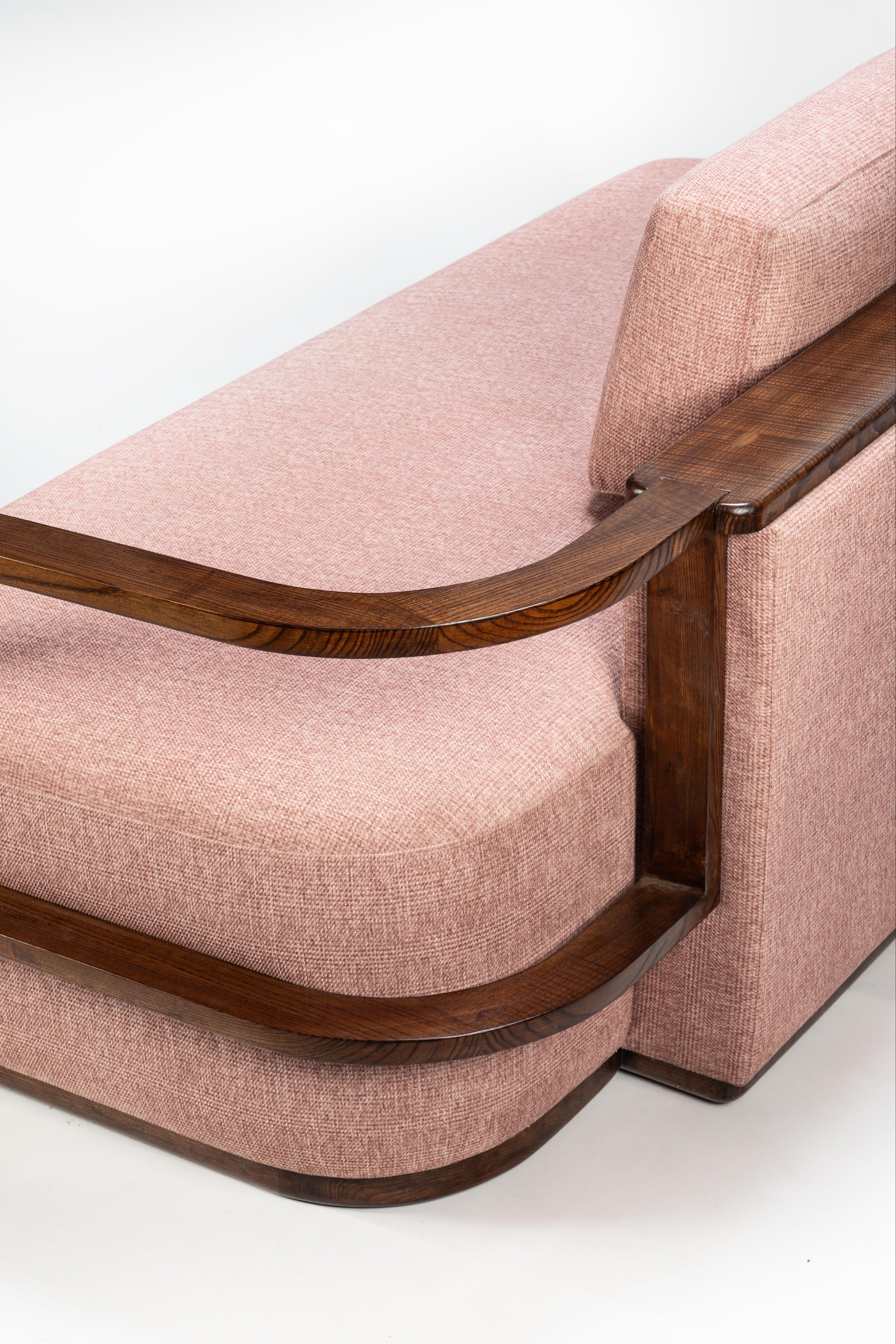 Pink sofa with wooden frame on a white background