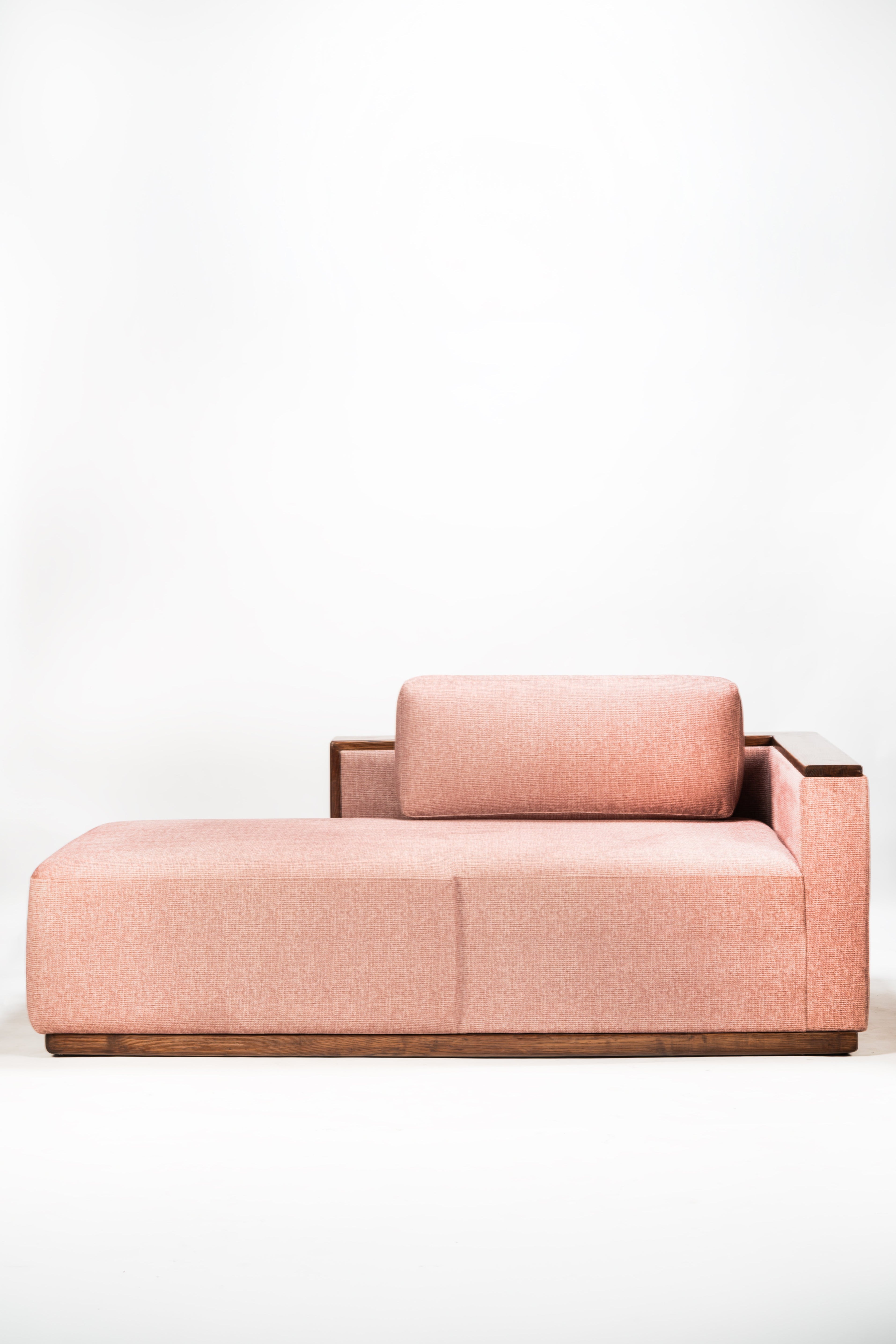 Pink sofa with a wooden frame on a white background
