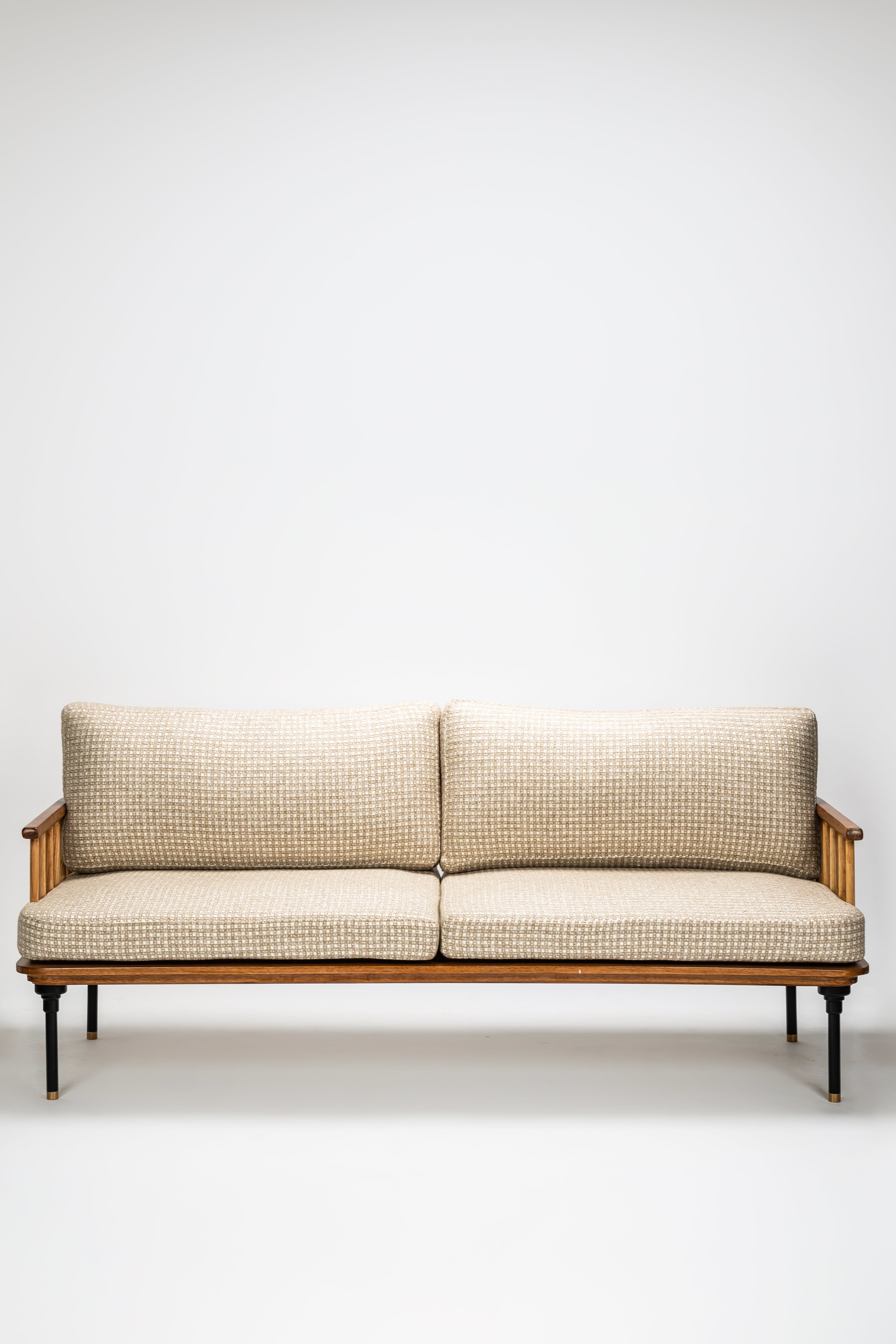 Beige sofa with wooden frame on a white background