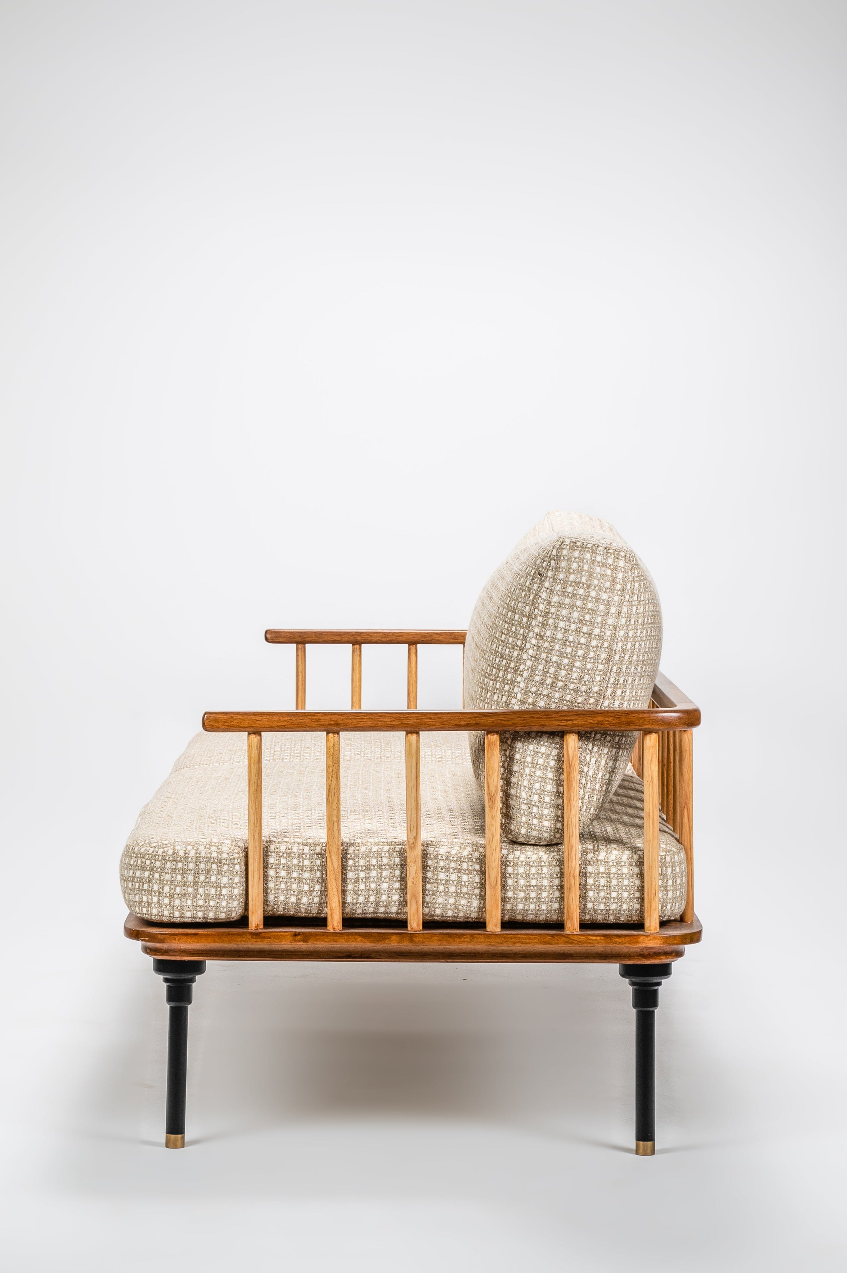Wicker chair with patterned cushions on a white background